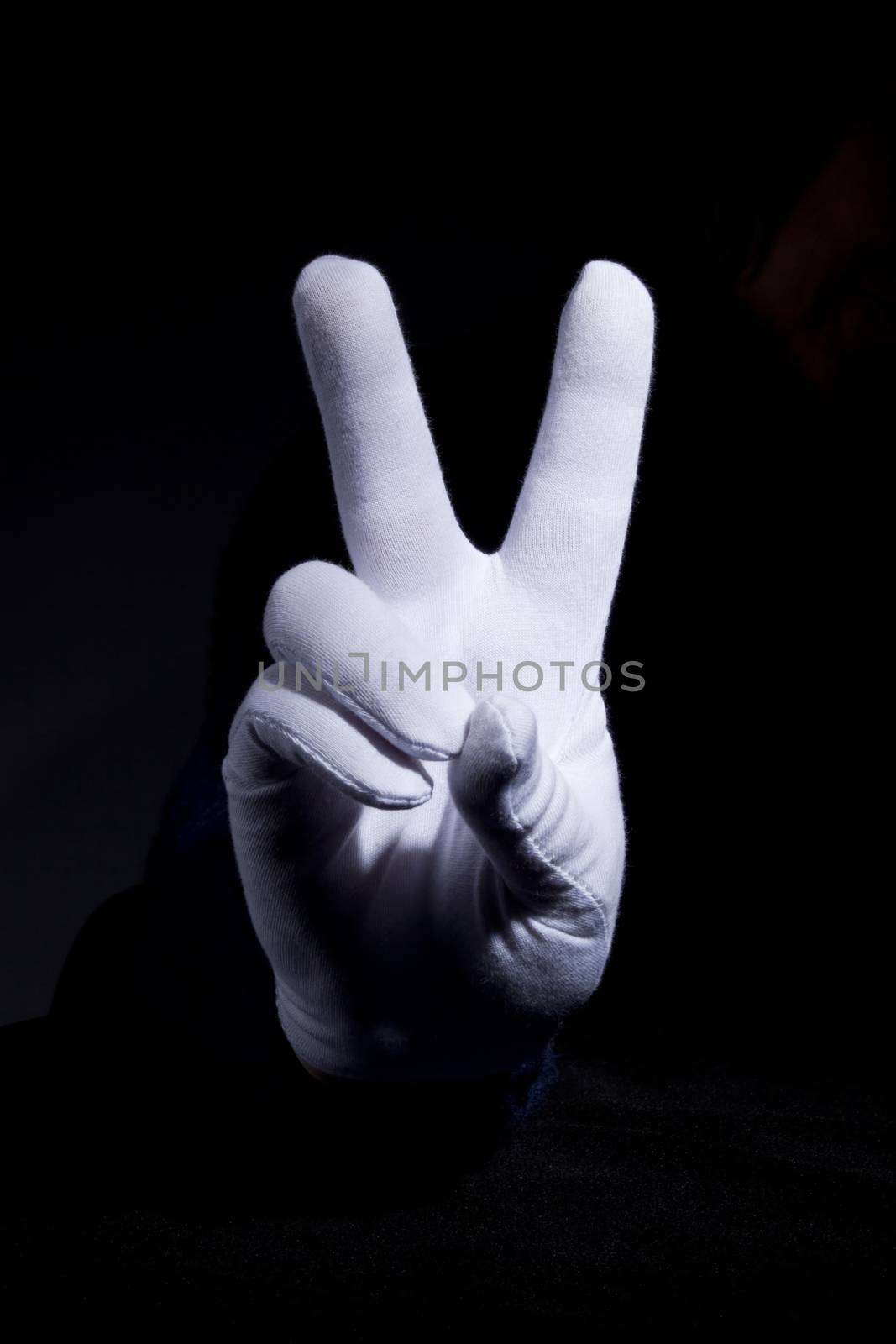 Hand in glove with white cloth gesturing
