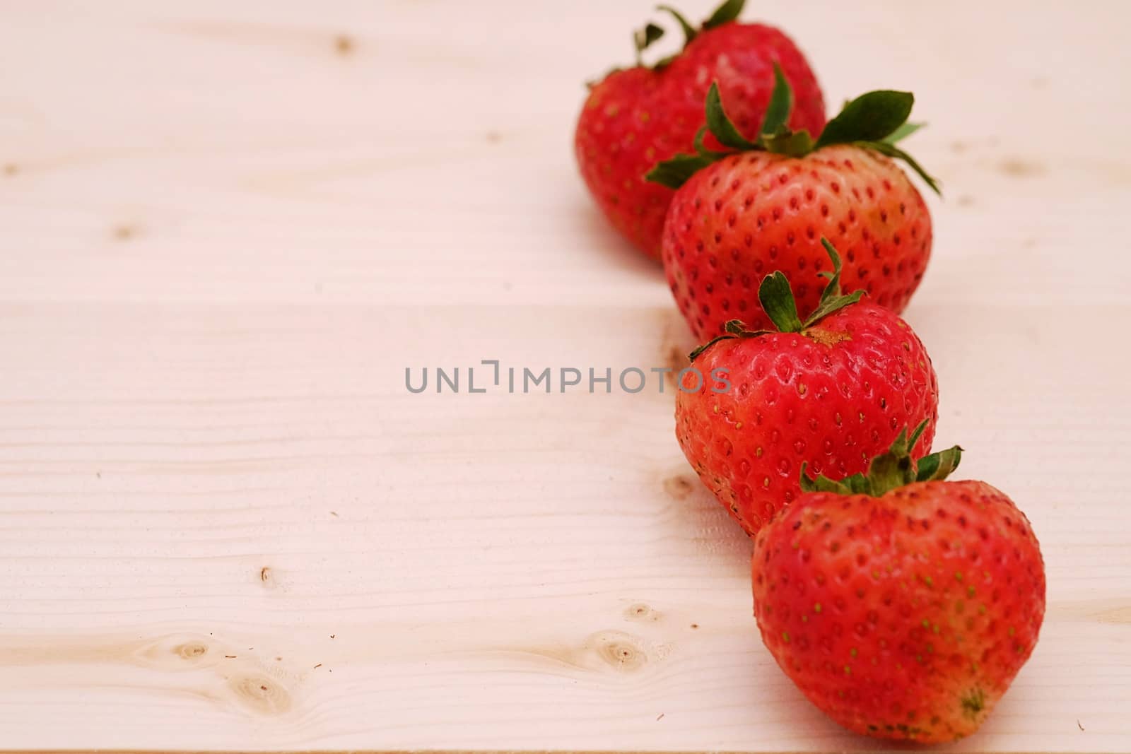 Row Red Strawberry Group on the Table Wood