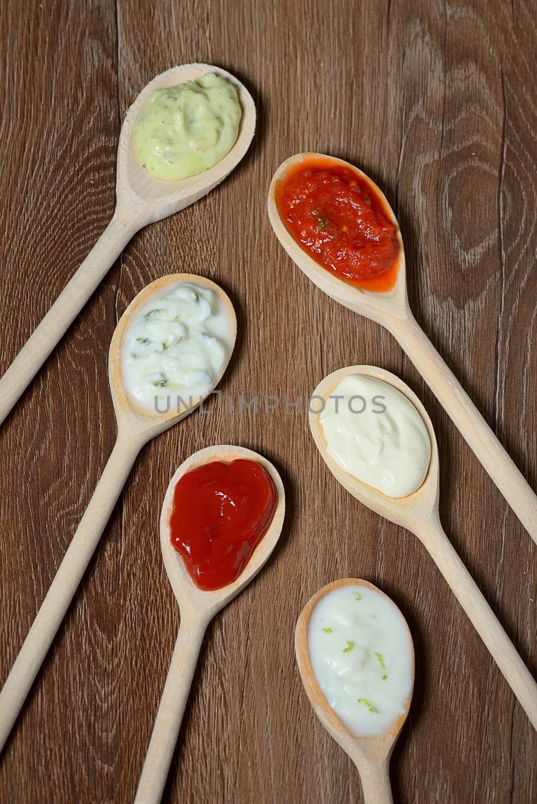 different types of sauces in spoons by mady70