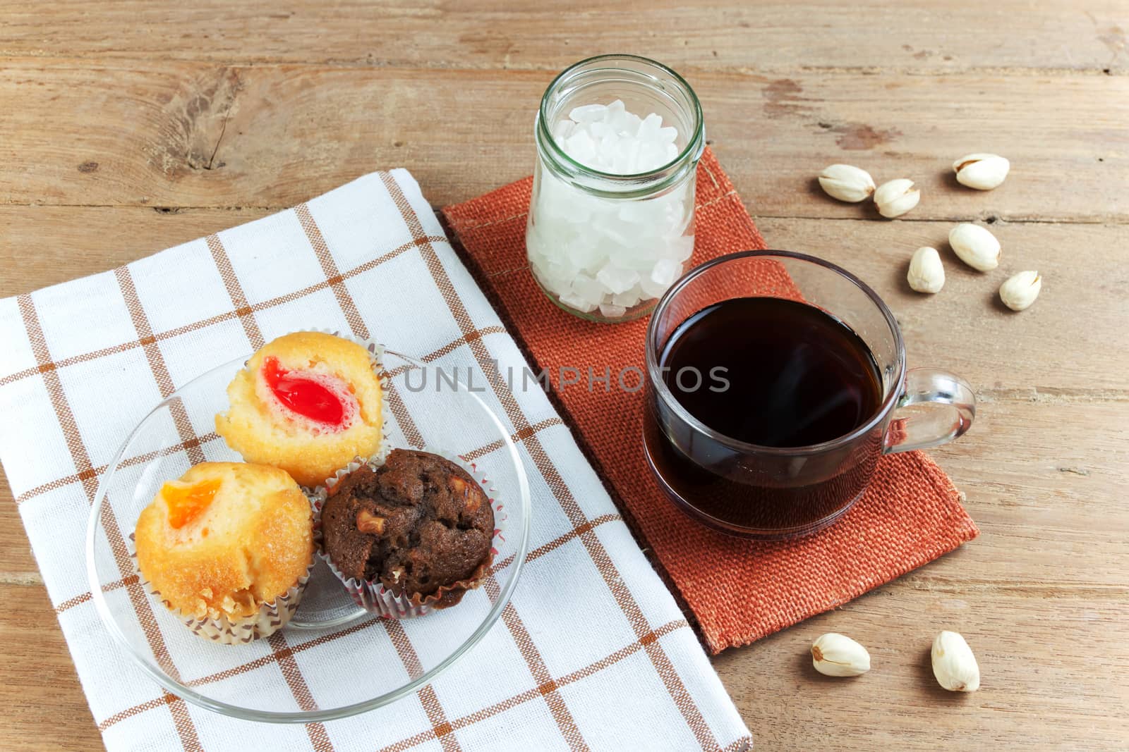 Cupcake various flavors in wood tray on wood table. coffee break