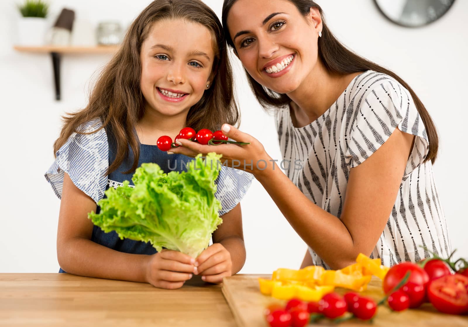 Shot of a mother and daughter having fun in the kitchen