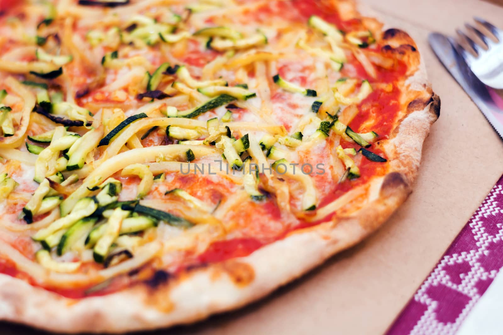 Close up of a tasty pizza with zucchini and potatoes