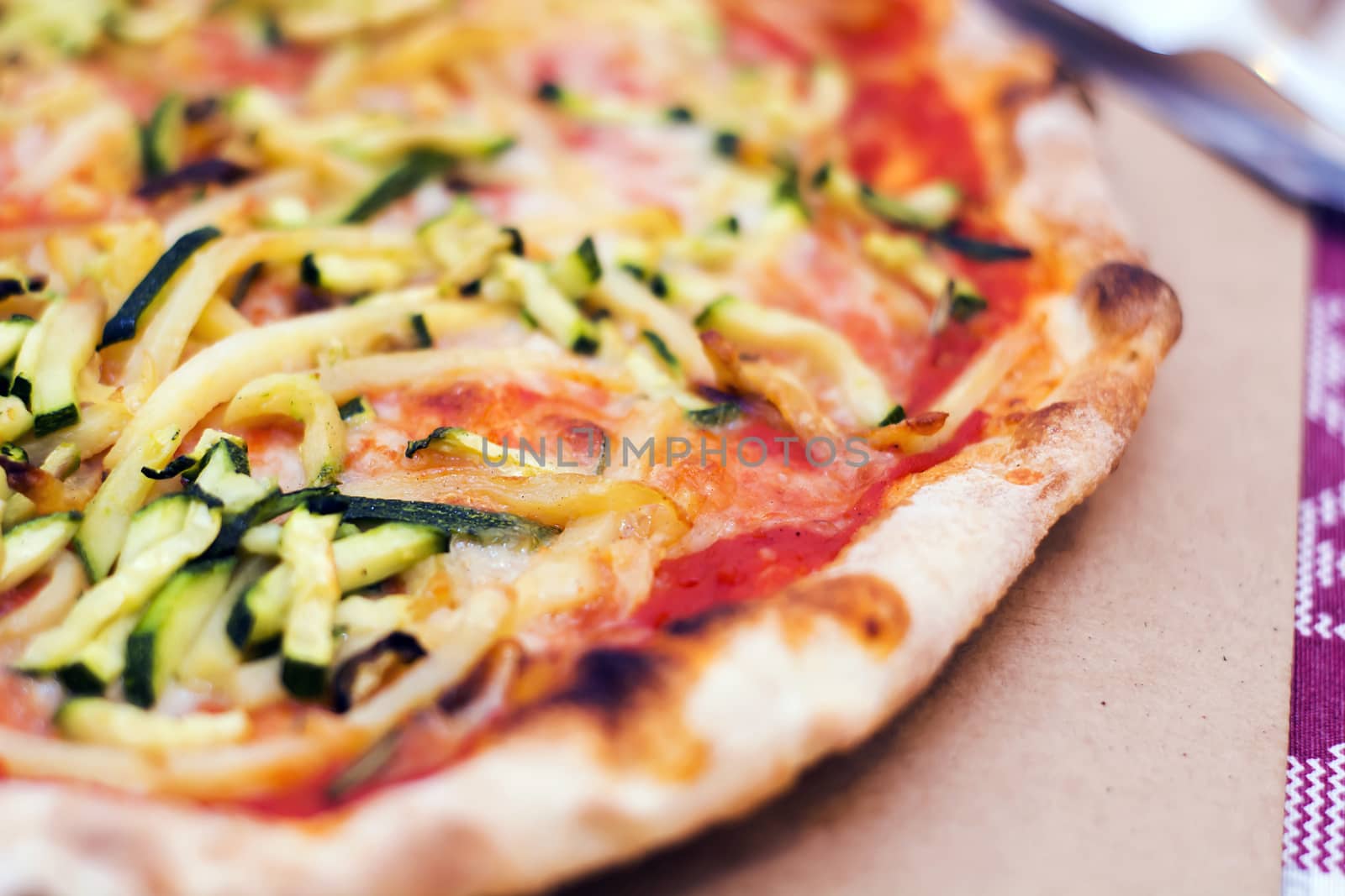 Close up of a tasty pizza with zucchini and potatoes