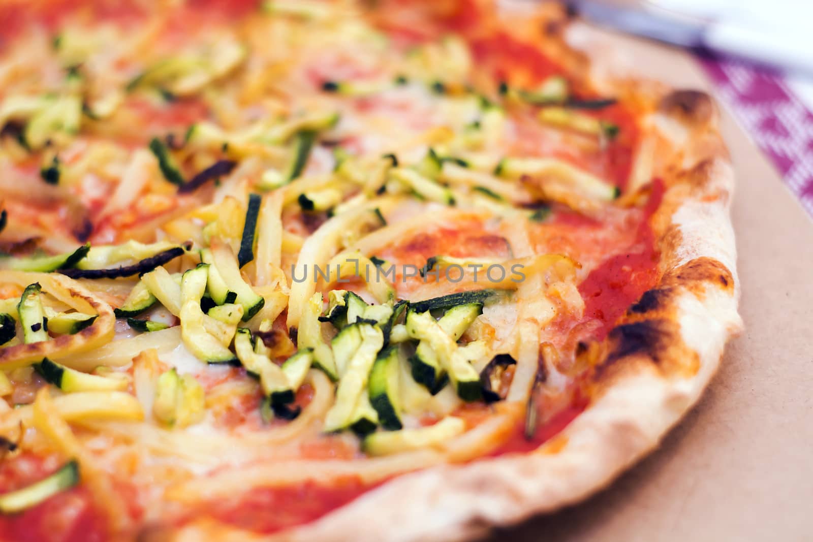 Close up of a tasty pizza with zucchini and potatoes