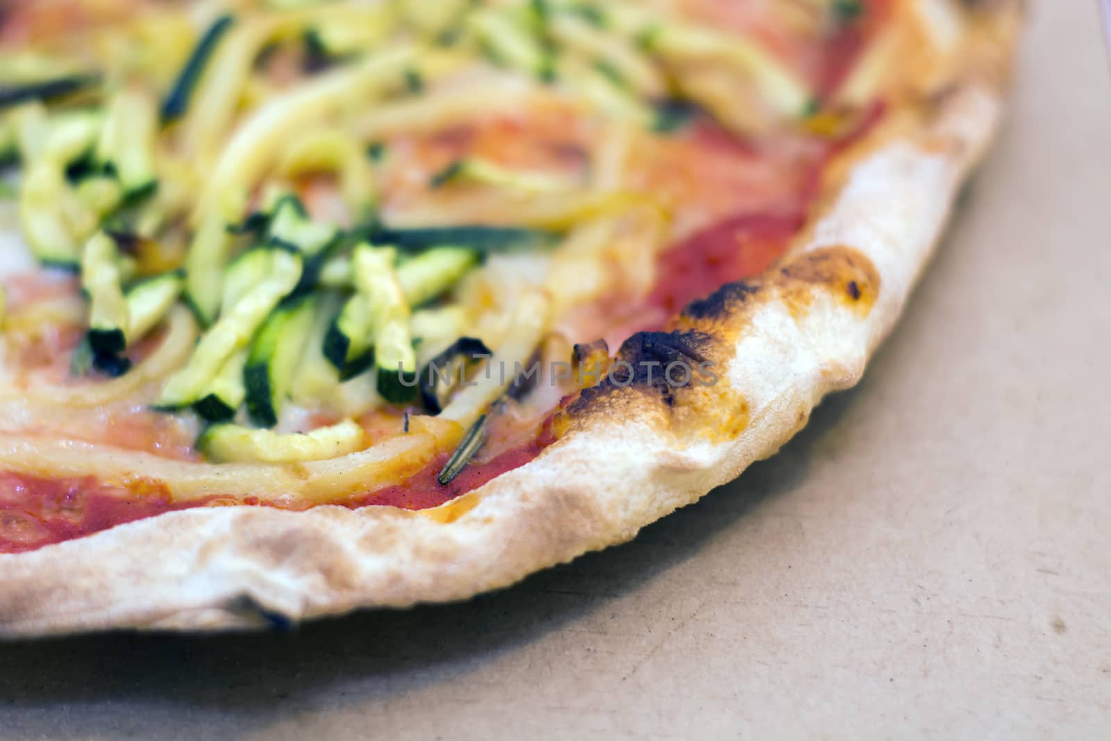 Close up of a tasty pizza with zucchini and potatoes