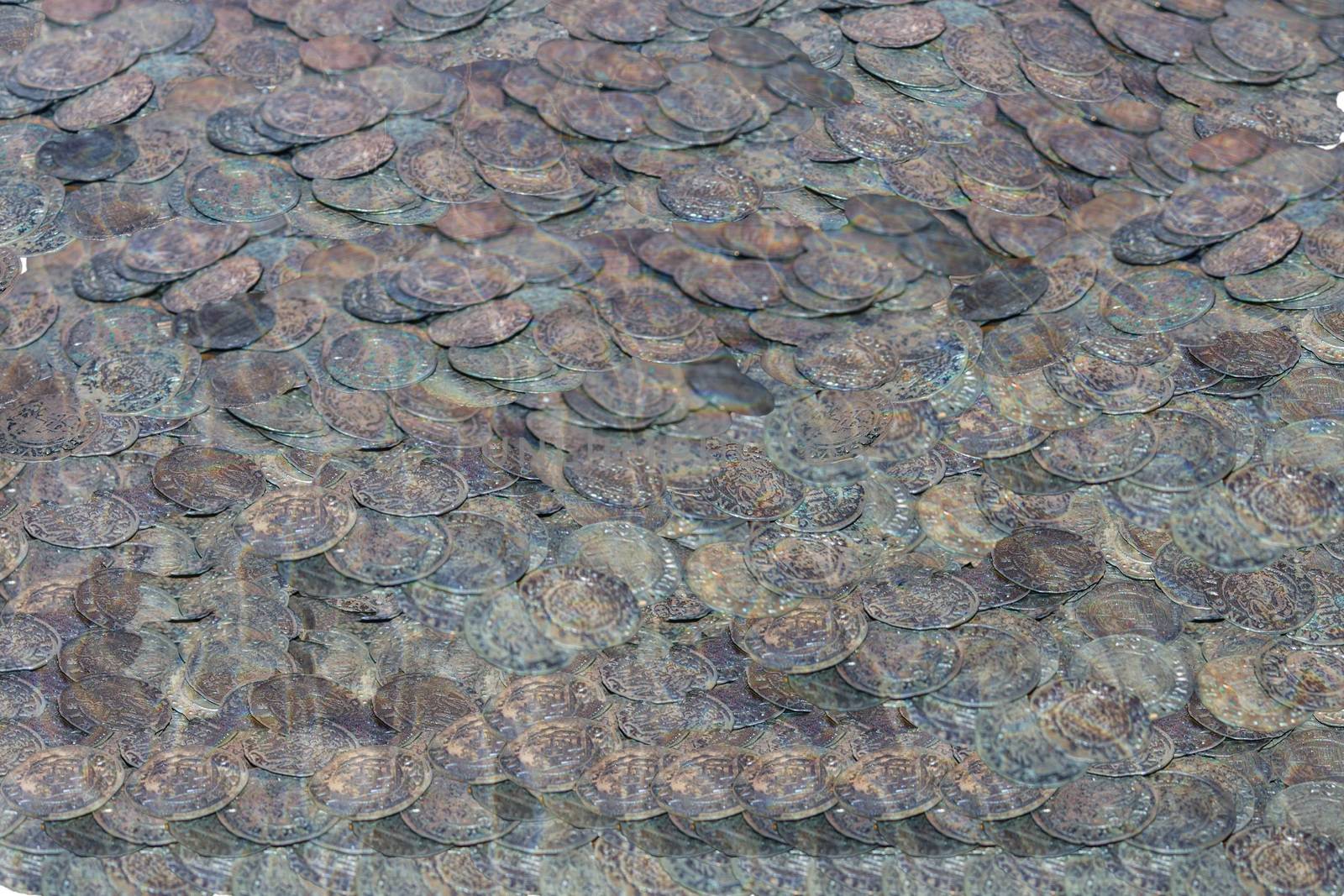 Old coins on the seabed. A treasure under water.