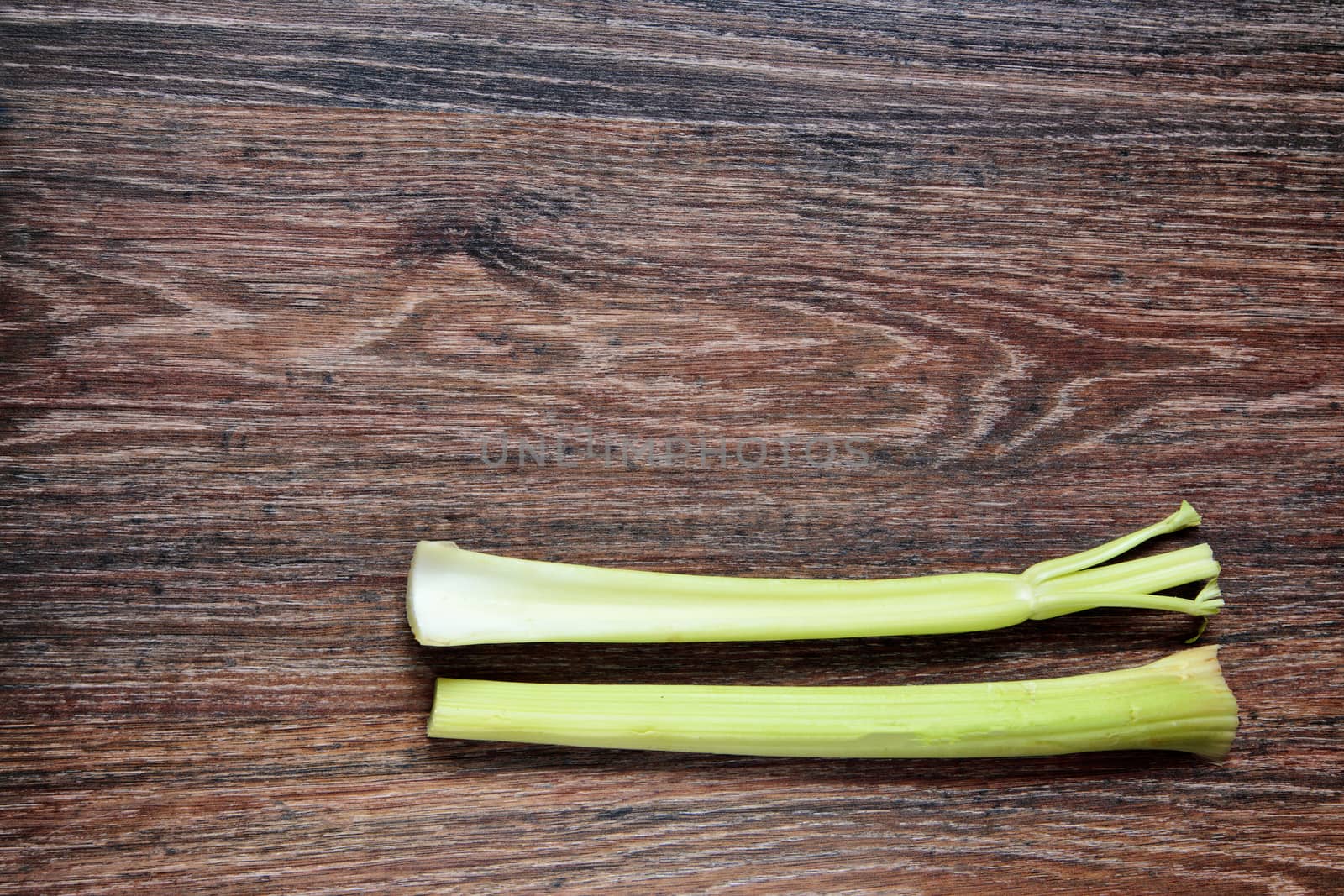 Celery on wood. Top View on wooden table with Copy Space. Ingredients for cooking