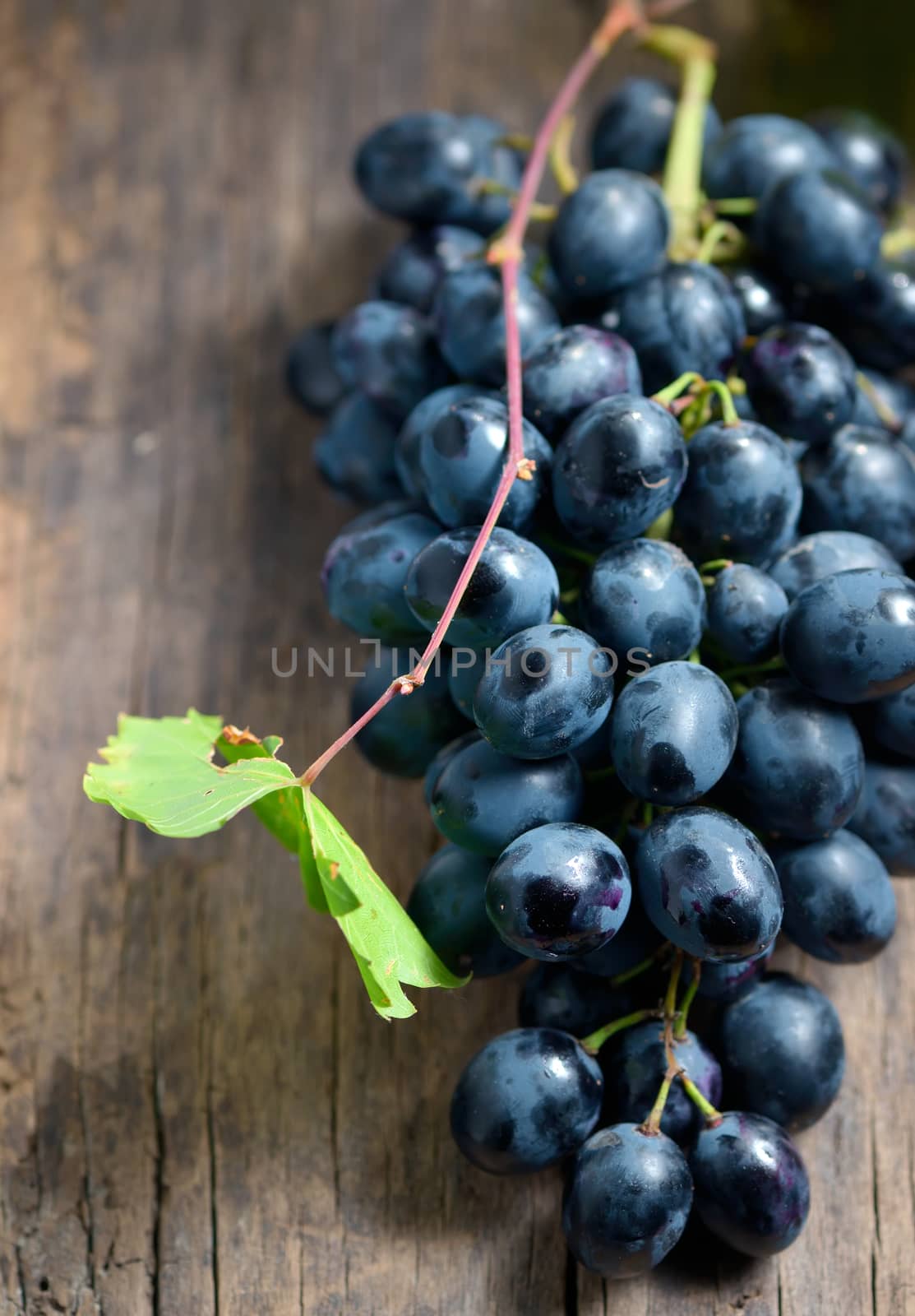 Bunch of red grapes on wooden table background