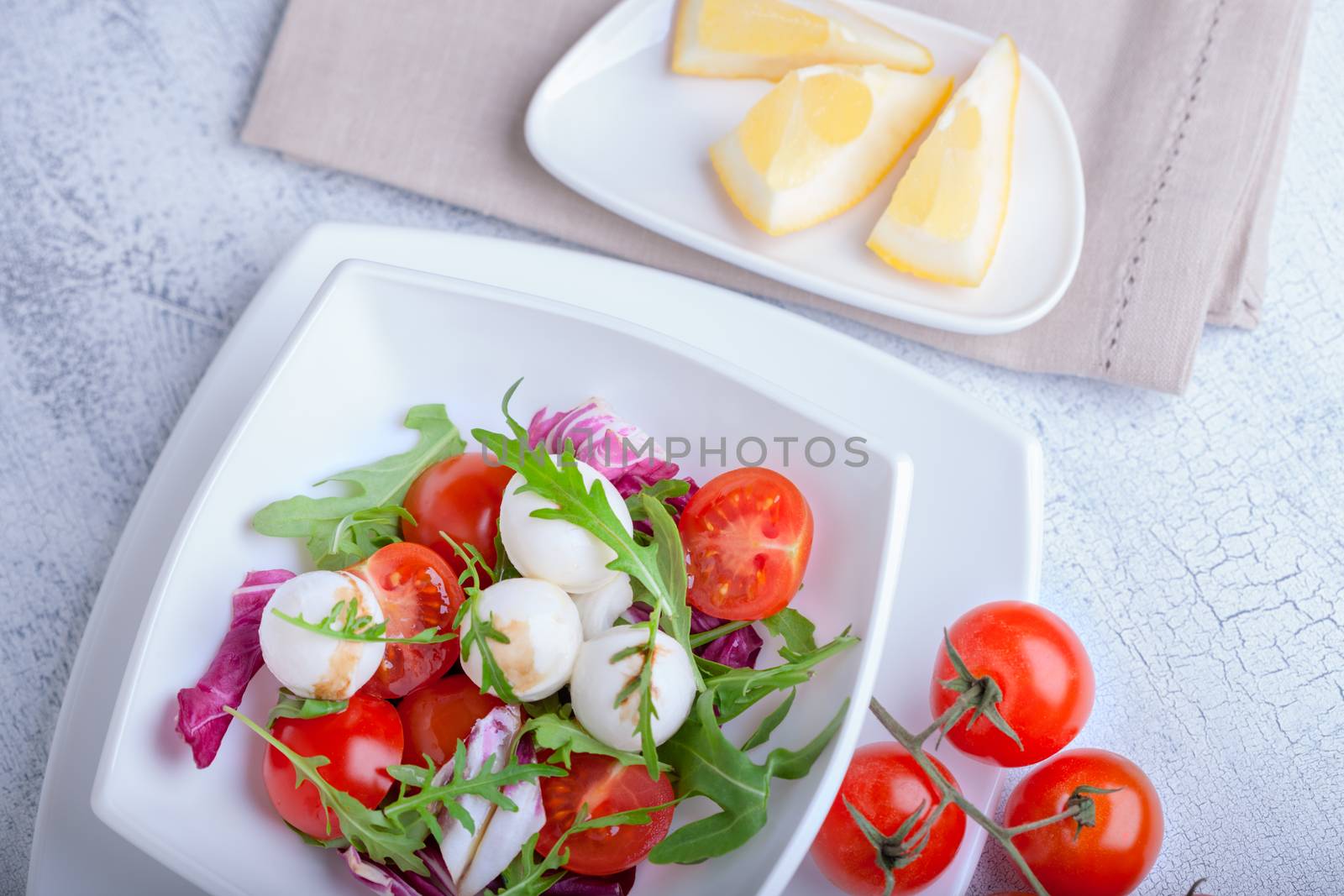 Fresh mozzarella balls served with spicy rocket leaves and cherry tomatoes.