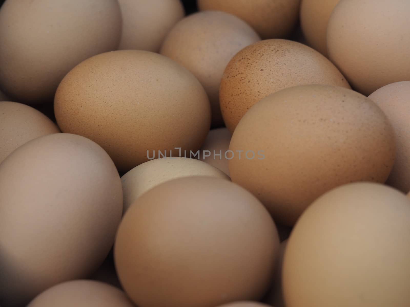 A Pile of Raw Fresh Brown Chicken Eggs Background by WernBkk