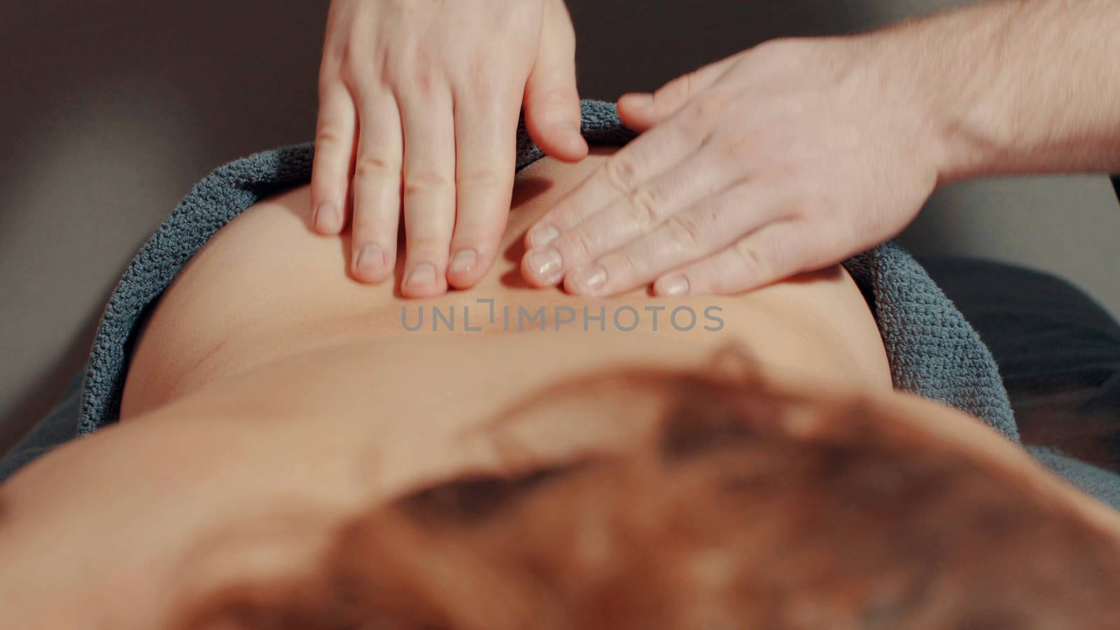 Man's hands massaging woman's back, close up