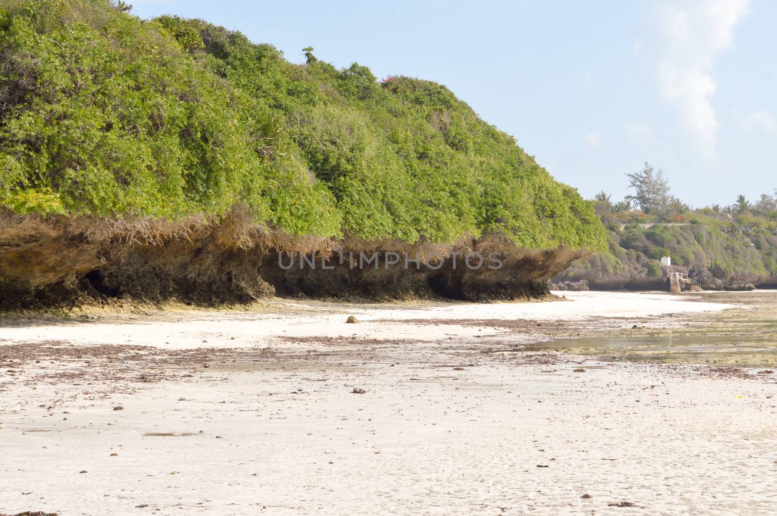 Small cove with a rock on the white sand of the bamburi beach in Mombasa, Kenya