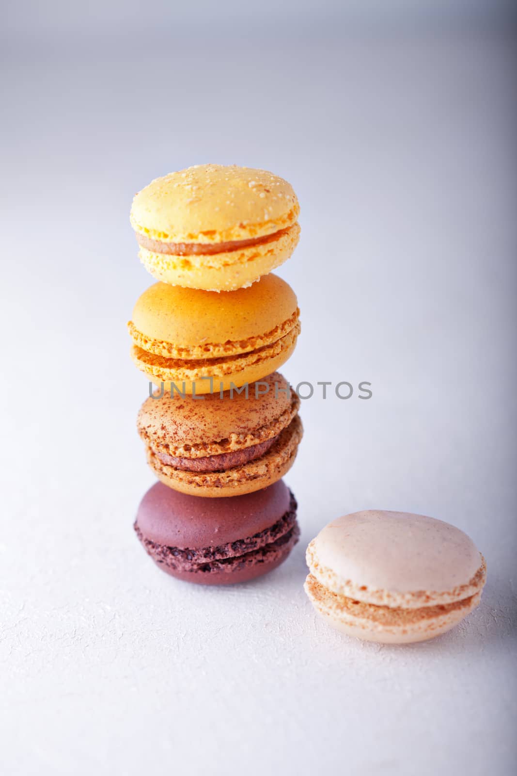 Colorful almond cookies macaroons on a white surface