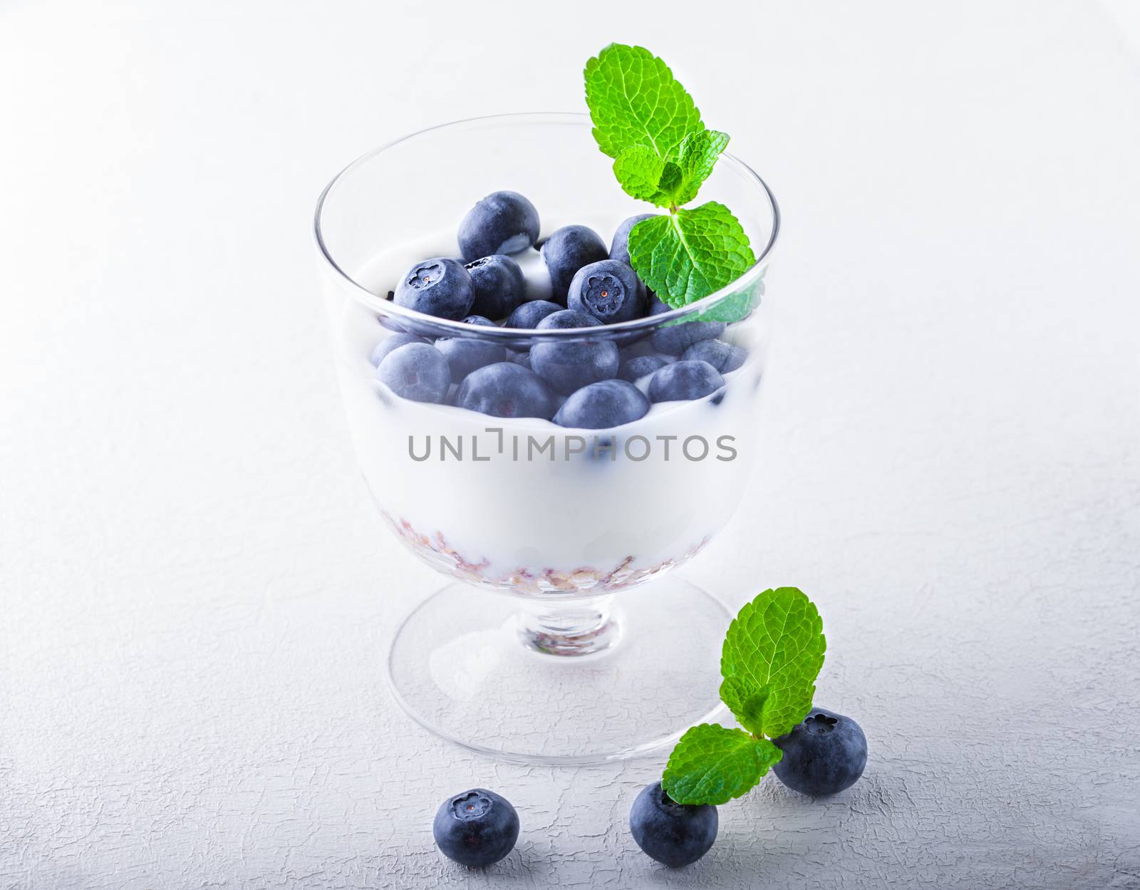 Yogurt with fresh blueberry and muesli in a glass