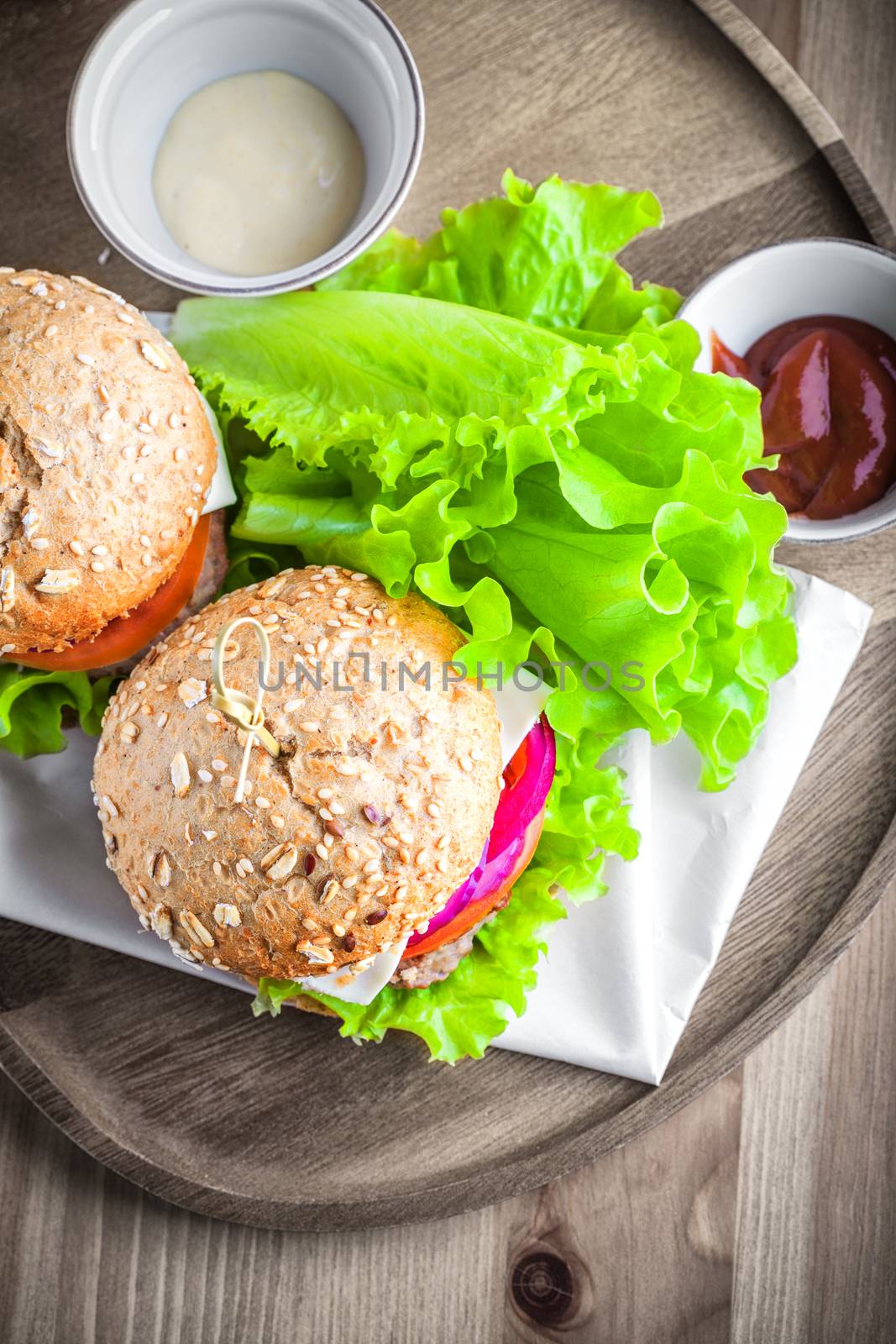 Cheeseburger with salad, onion, tomato and fresh bread