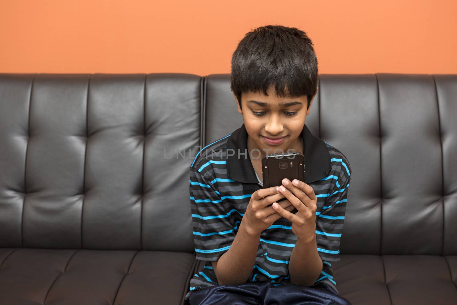 an handsome kid addicted to his cell phone