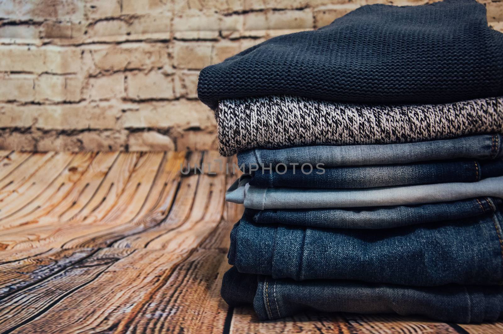 fashionable clothes. pile of jeans by natali_brill