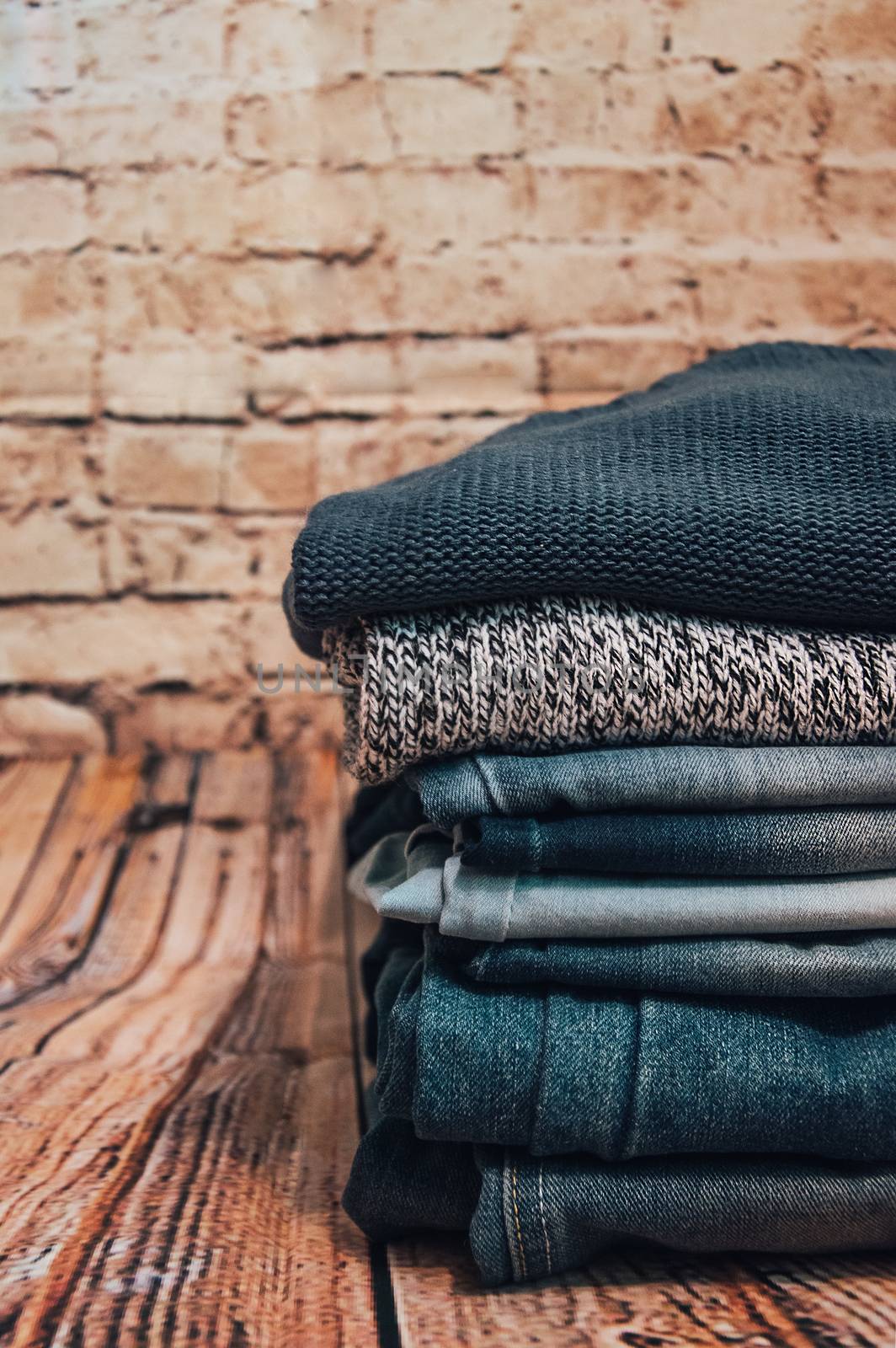 fashionable clothes. pile of jeans on a wooden background