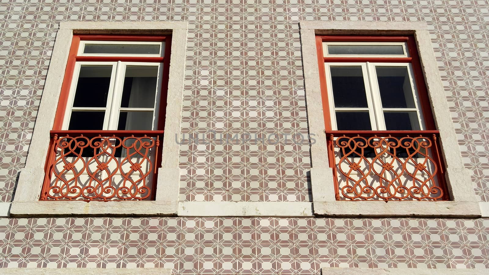 Detail of an old building with portuguese tiles and red and white windows, Lisbon, Portugal