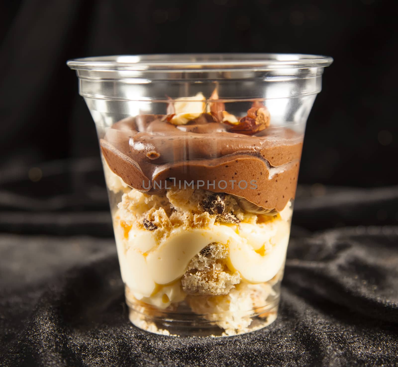 Chocolate cake with nuts and cream in cup by RawGroup
