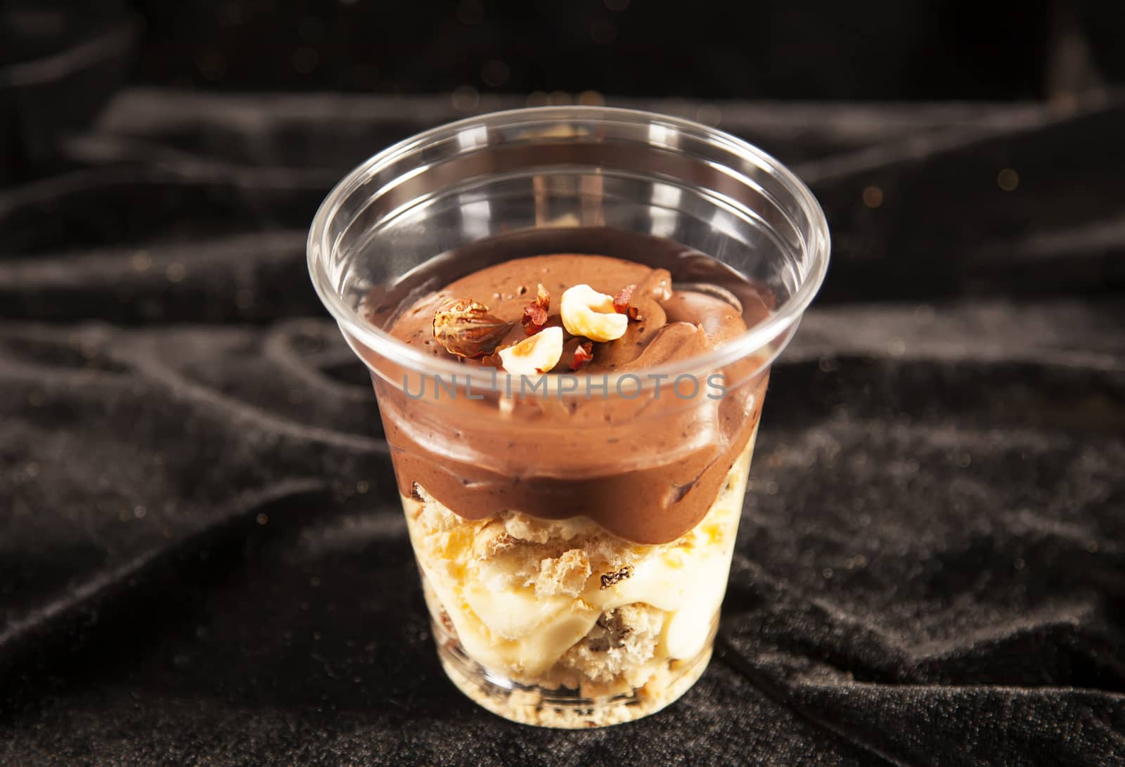 Chocolate cake with nuts in plastic cup by RawGroup