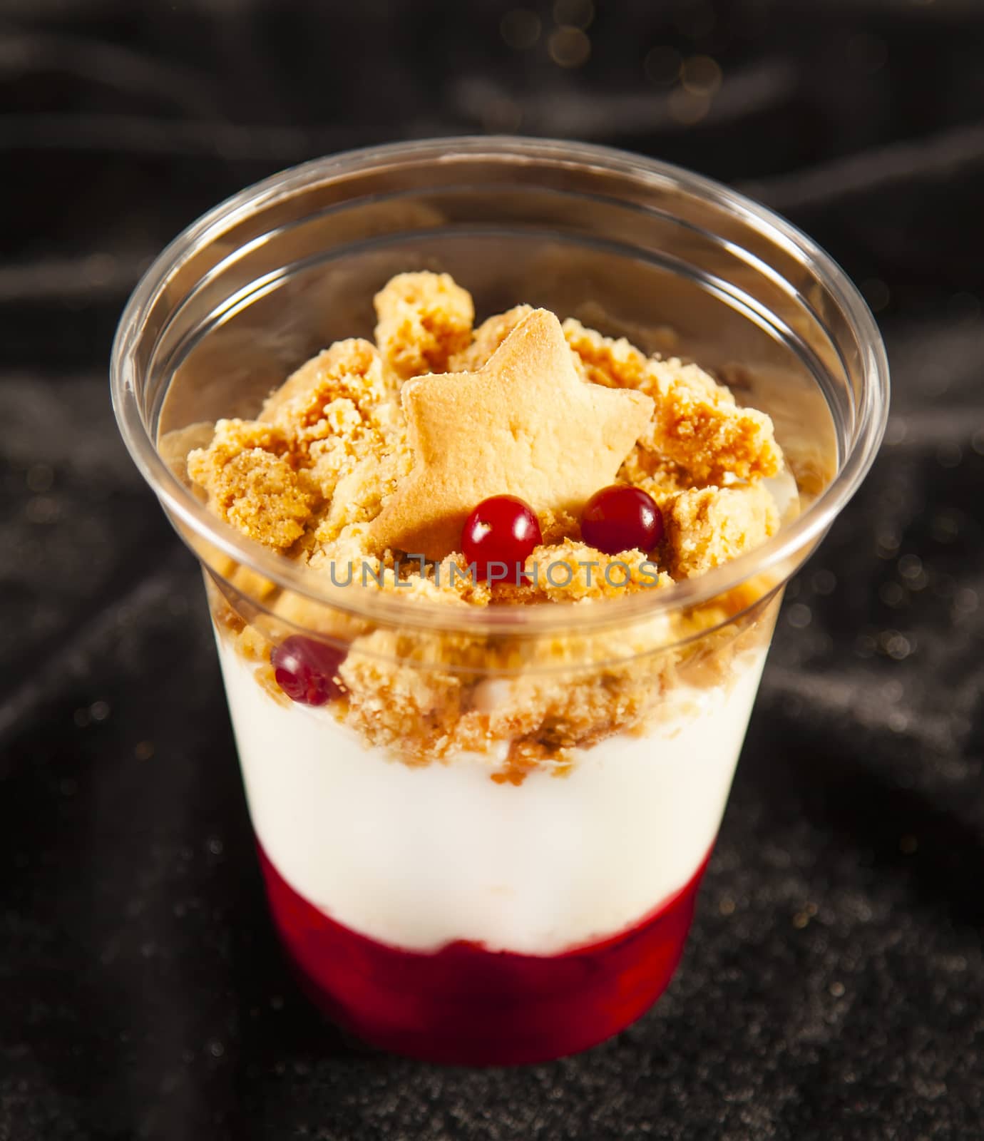 Sweet tasty cherry trifle on black background