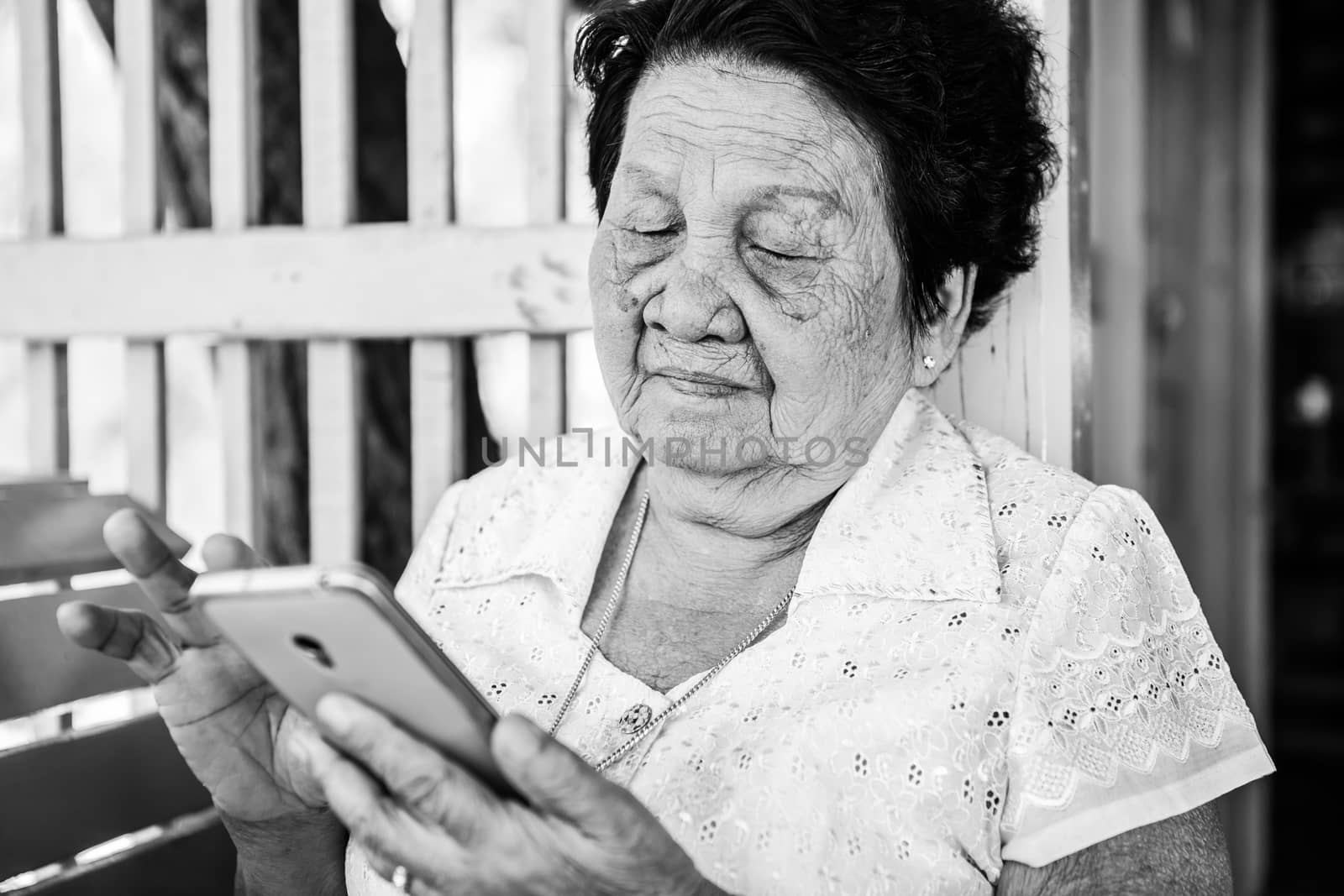 Senior asian woman  with smart phone by witthaya