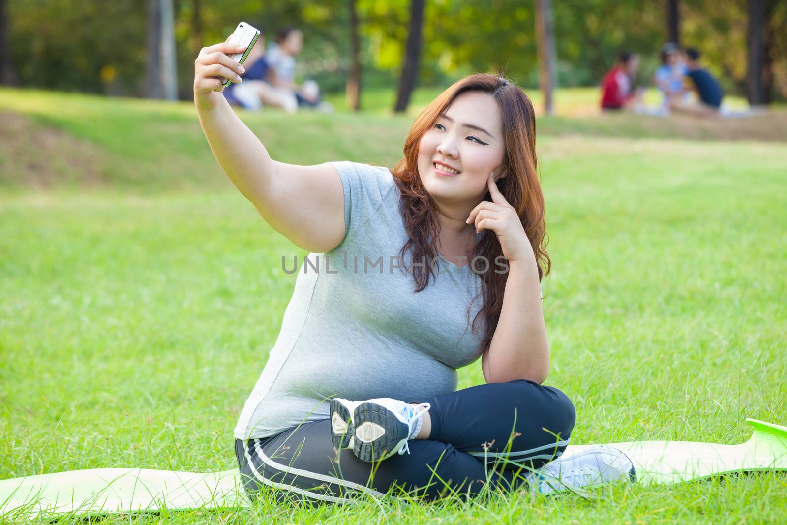 Pretty fat female takes travel selfie at the park