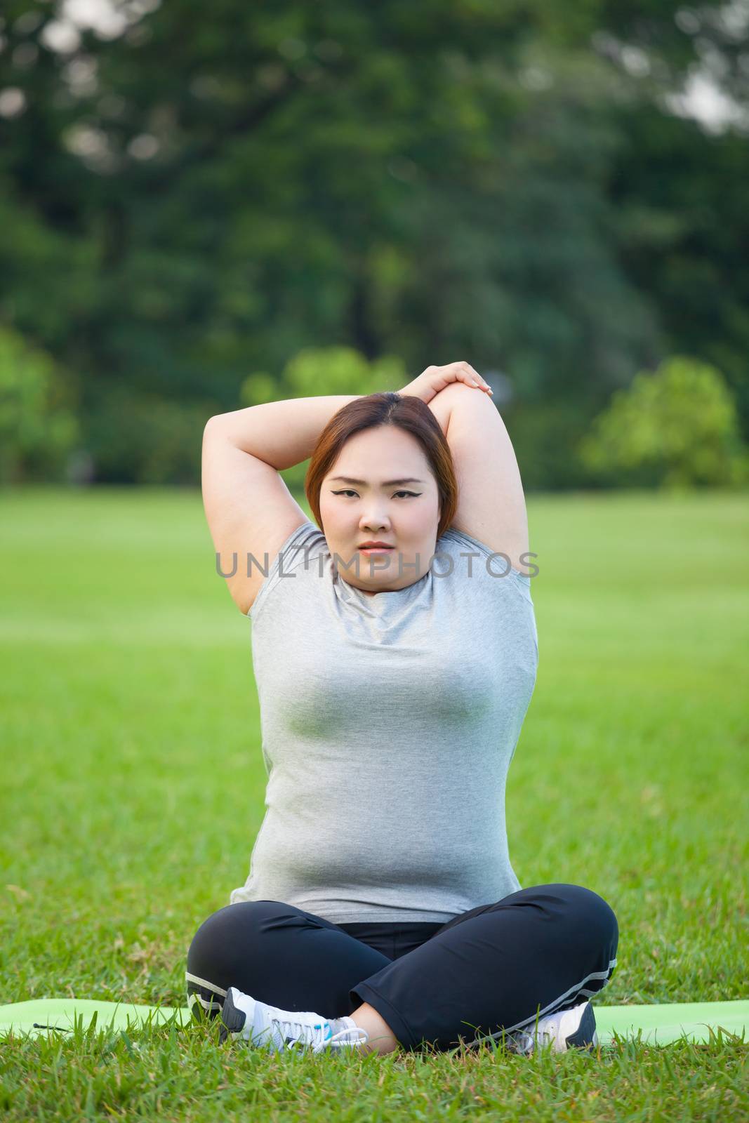 Happy fatty asian woman posing outdoor in a park