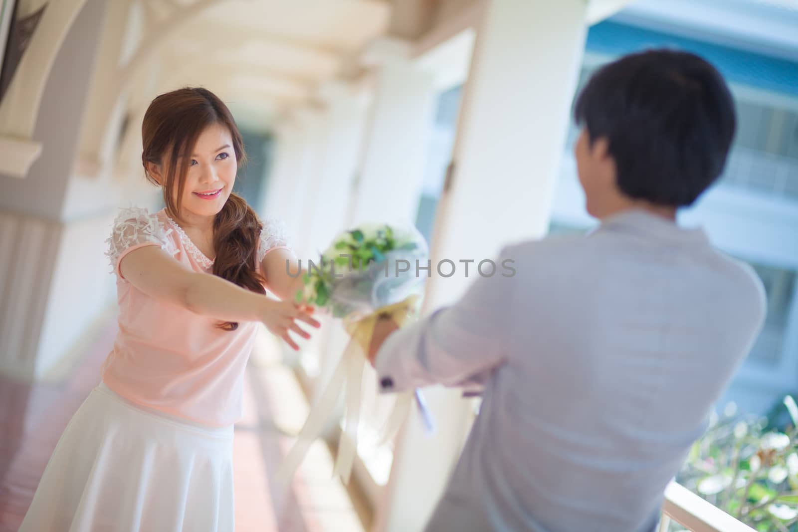 Man ready to give flowers to girlfriend