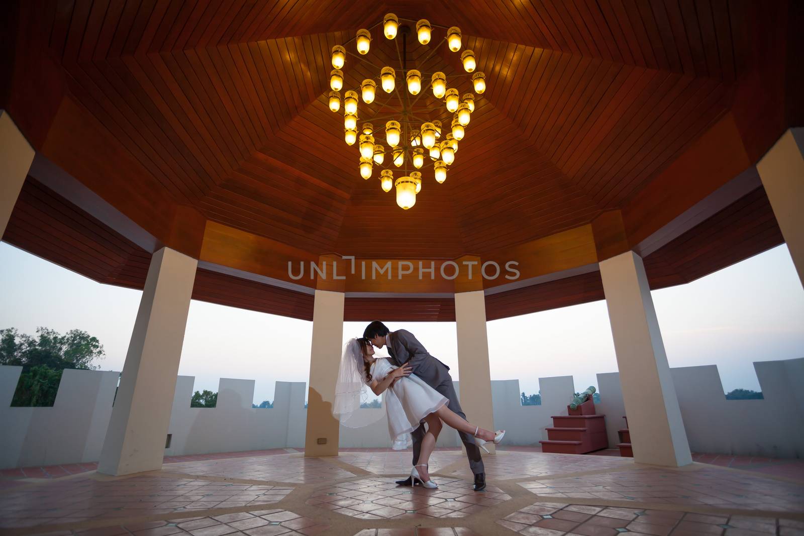 Loving asian couple indoor by witthaya