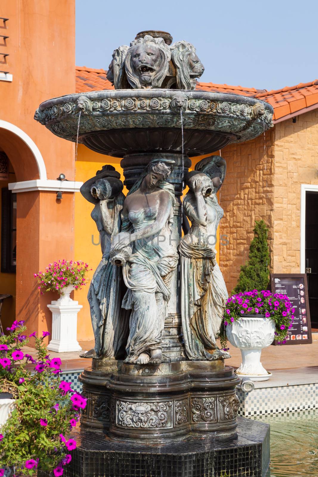 View of fountain and restaurant with garden