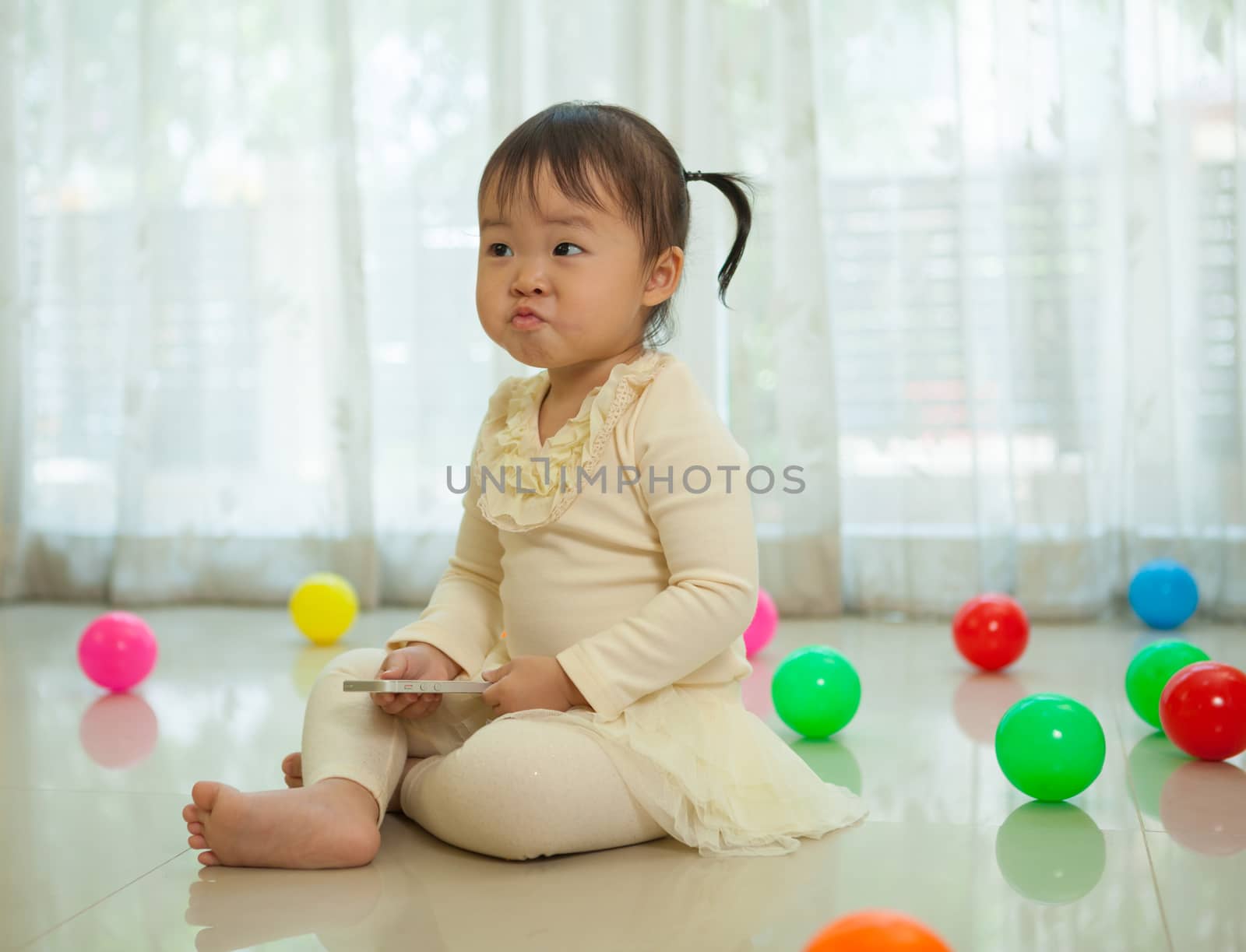 Portrait of little asian girl in home by witthaya