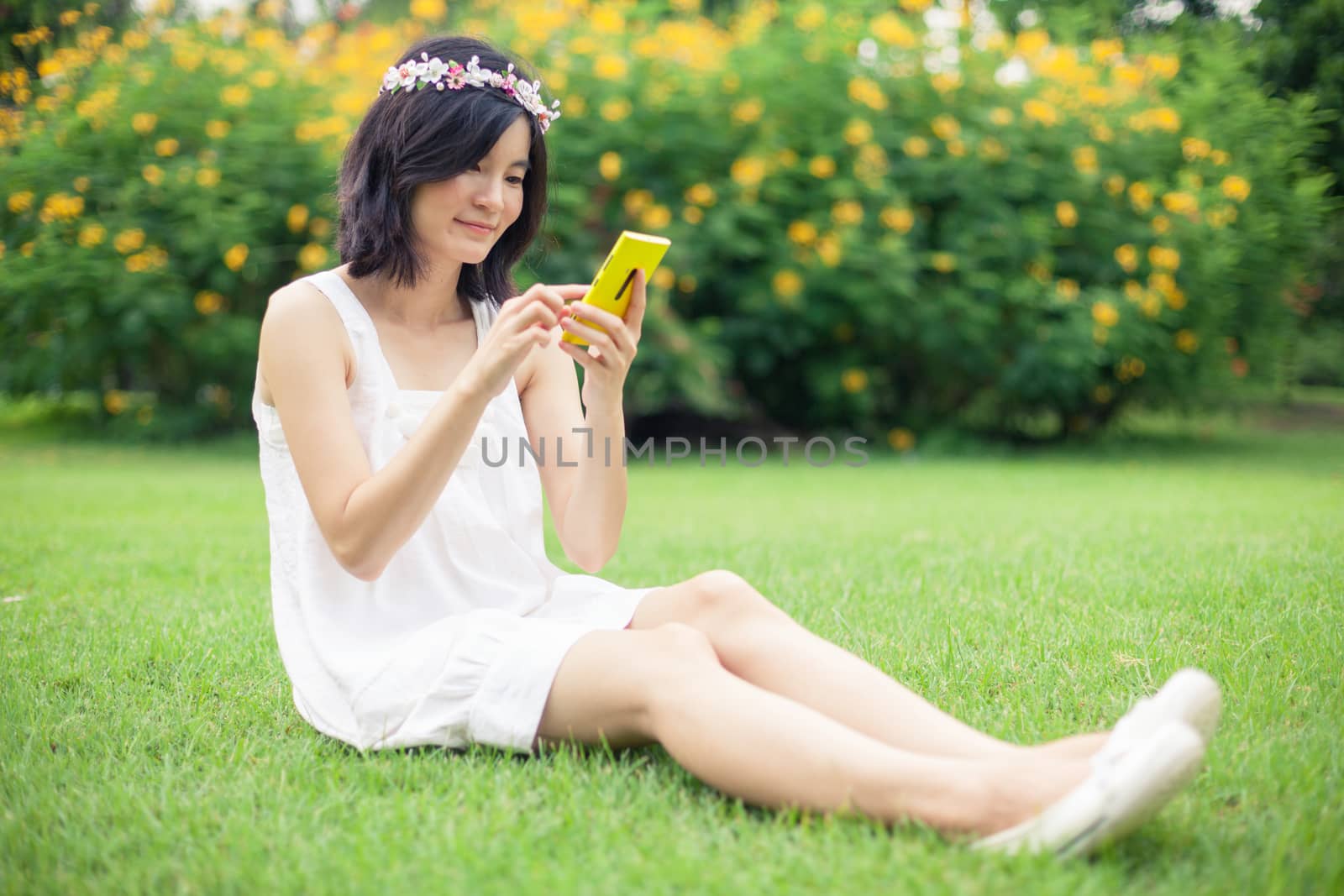 Woman using mobile smart phone by witthaya