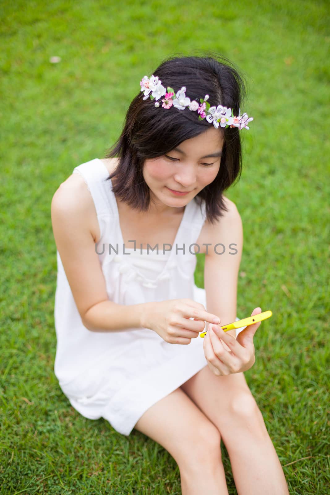 Woman using mobile smart phone by witthaya