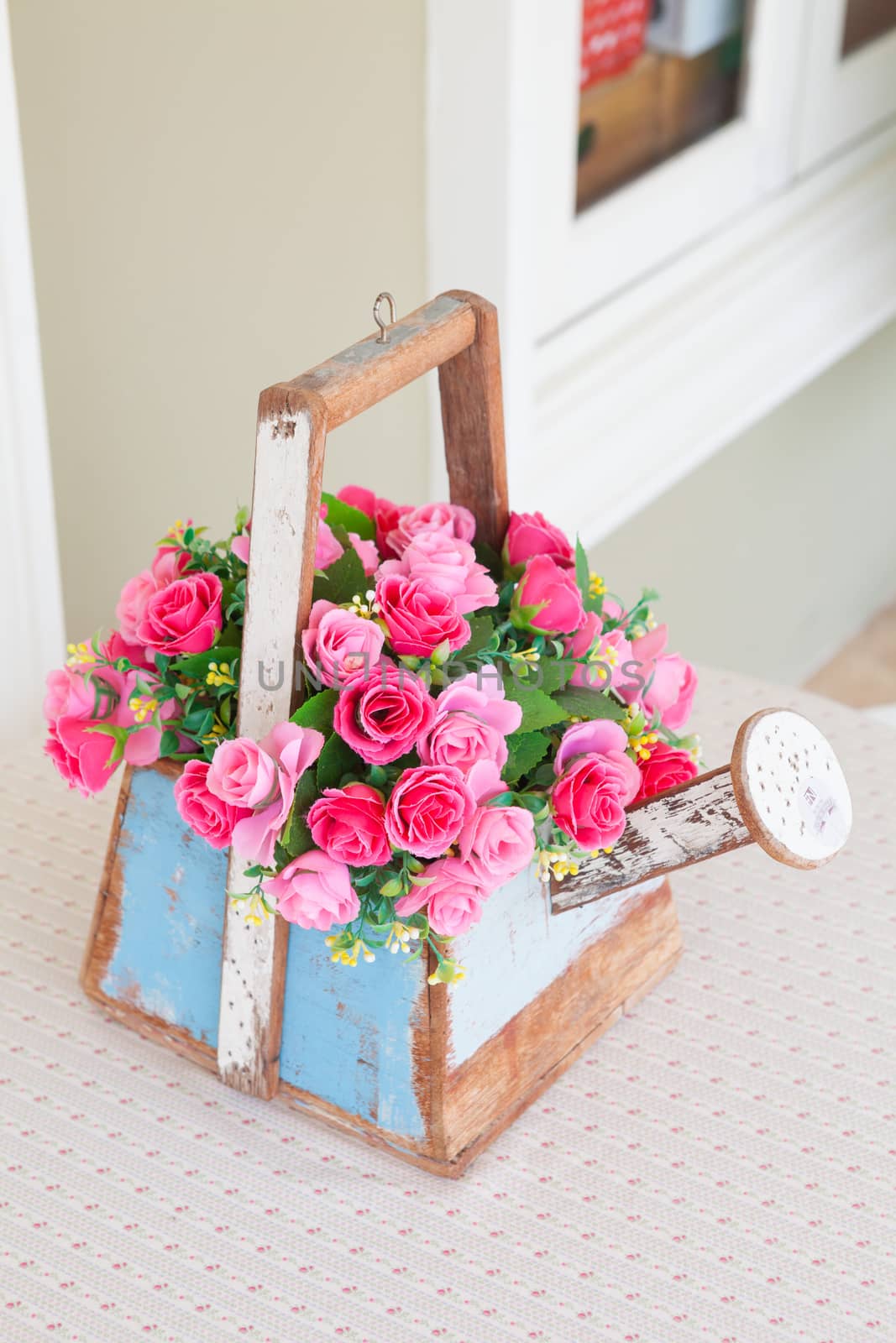 Roses in wood basket on wood table