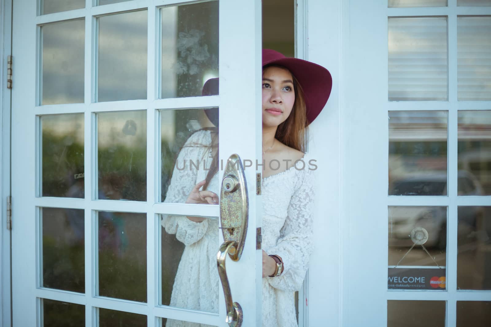 Sad asian vintage woman looking out the door