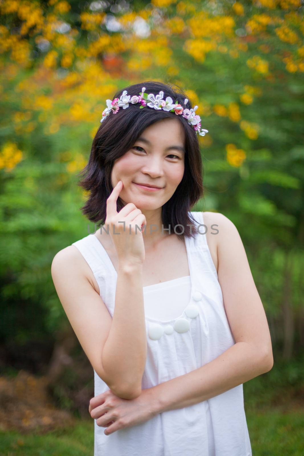 Beautiful asian young woman with a crown of flowers