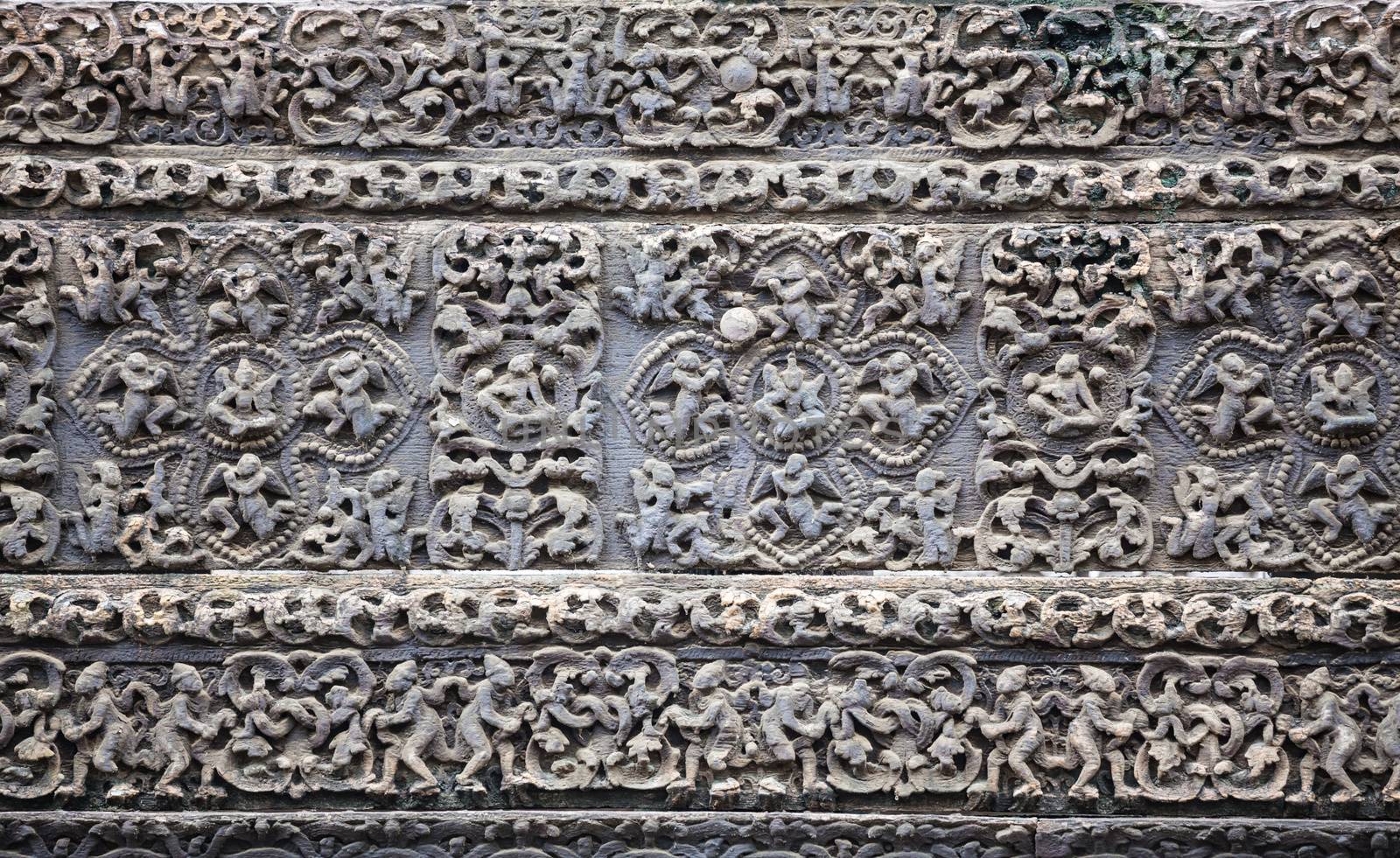 Old stone carvings on the wall temple in Myanmar