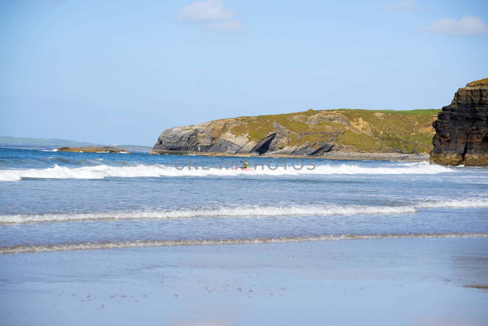 sunny winter view of kayaker at ballybunion by morrbyte