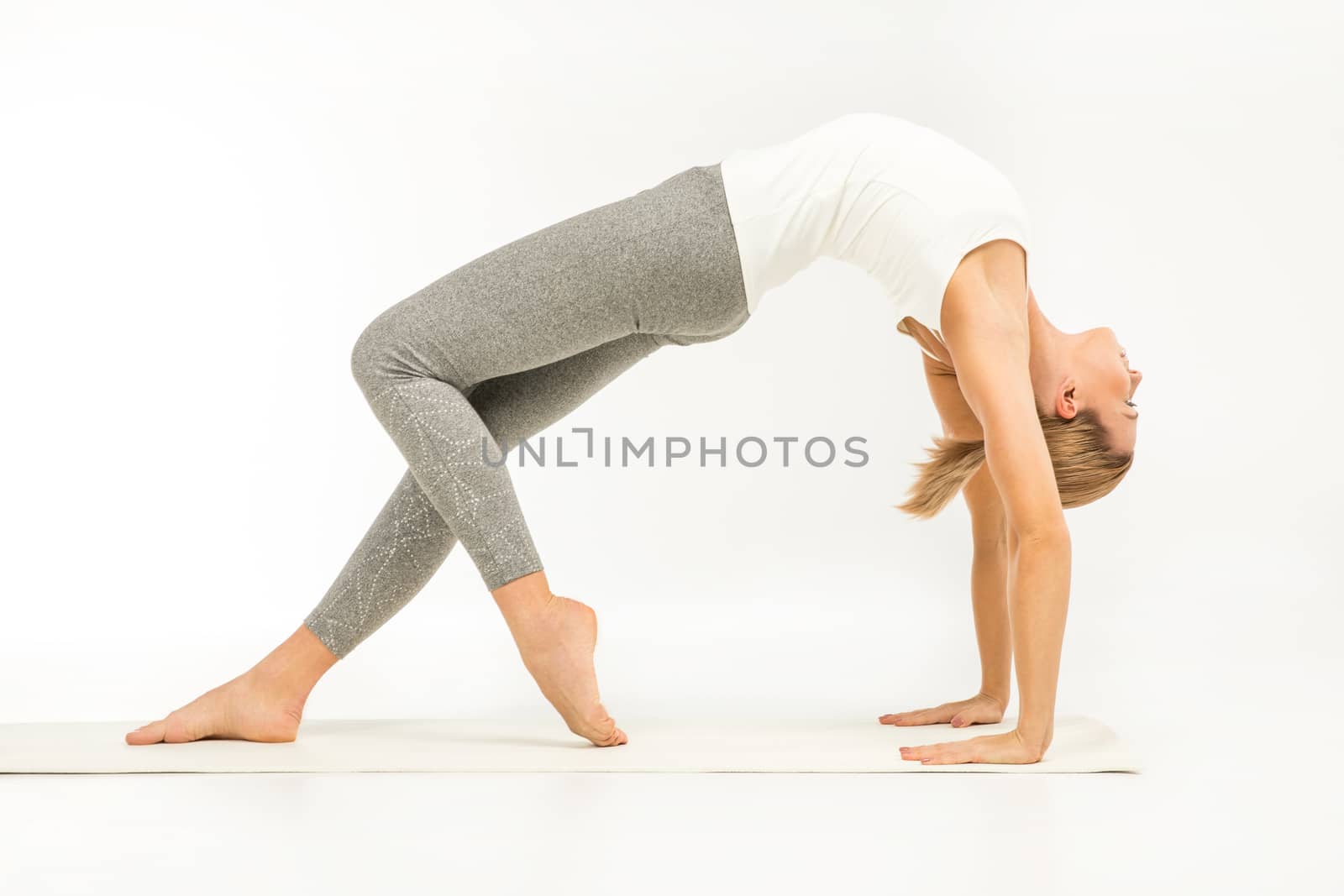Woman standing in yoga position    by LightFieldStudios