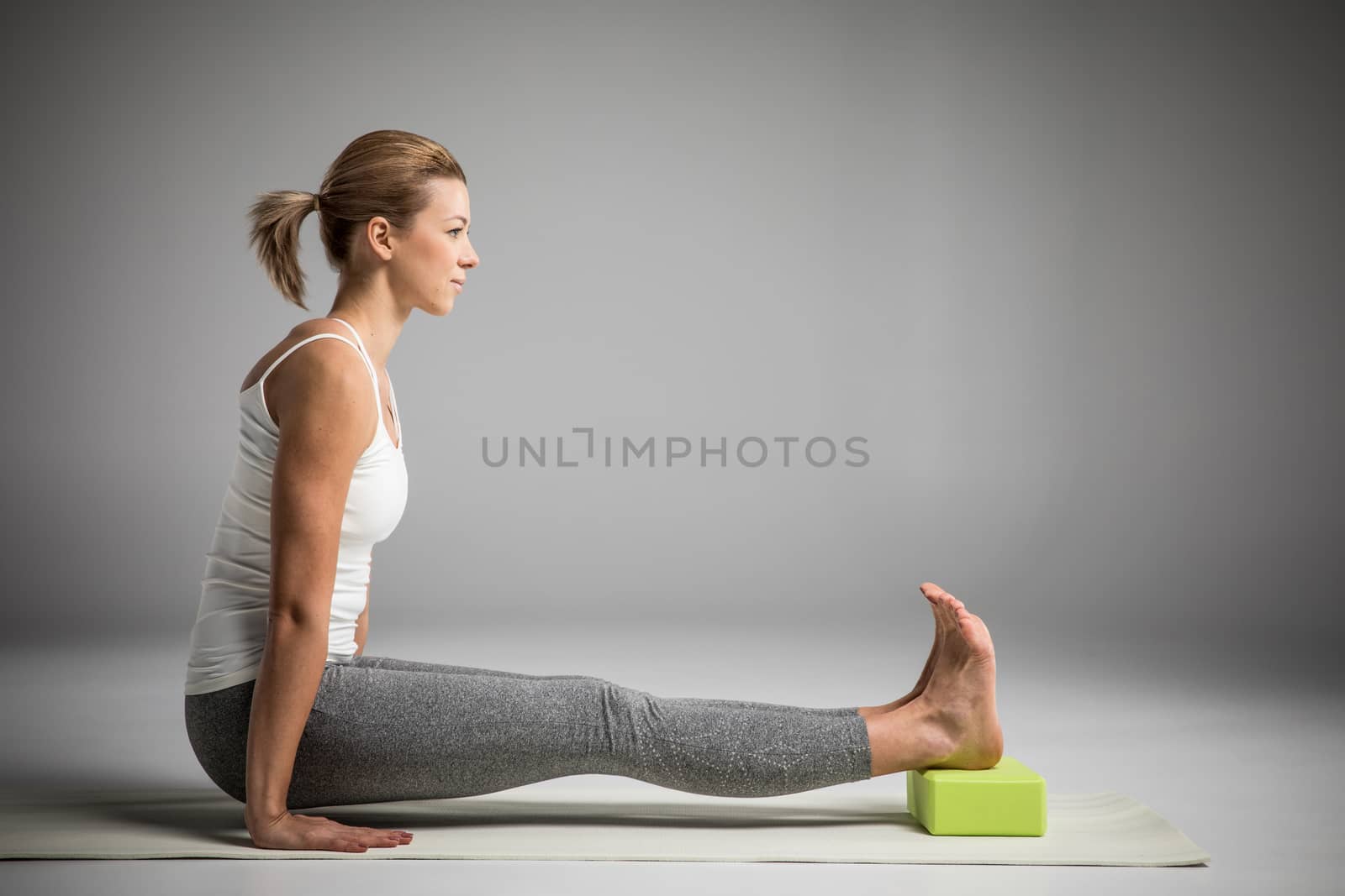 Woman practicing yoga by LightFieldStudios