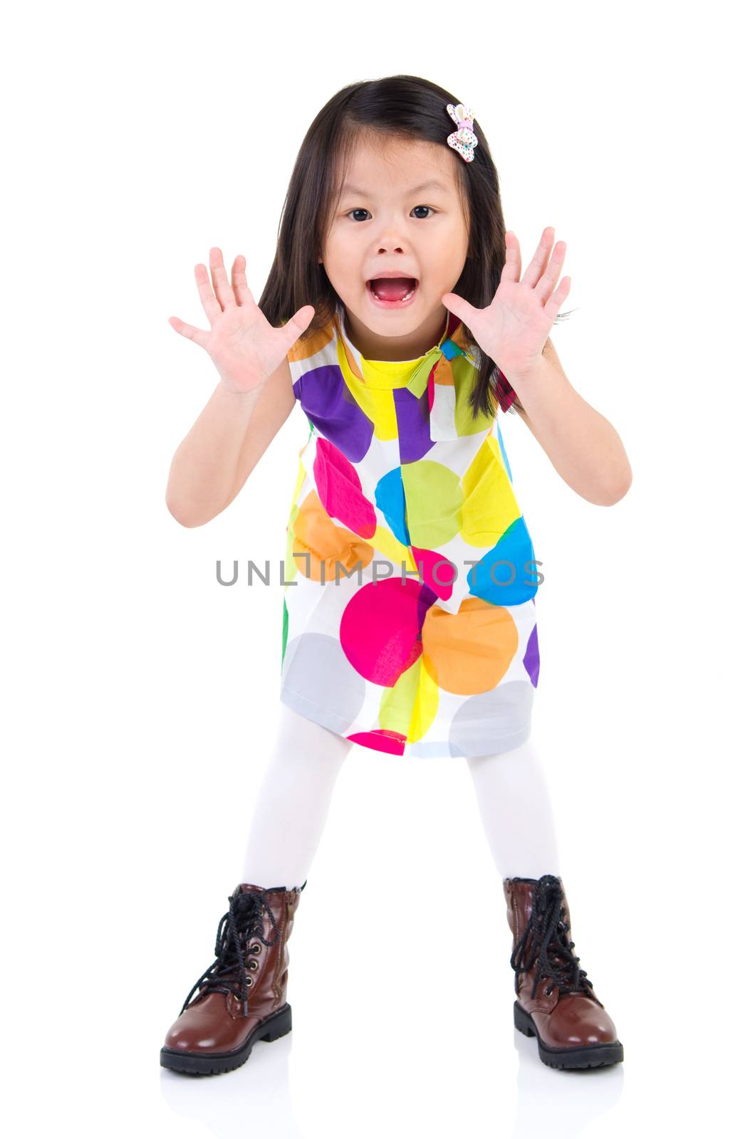 Excited asian little child open her mouth and raising her hand 