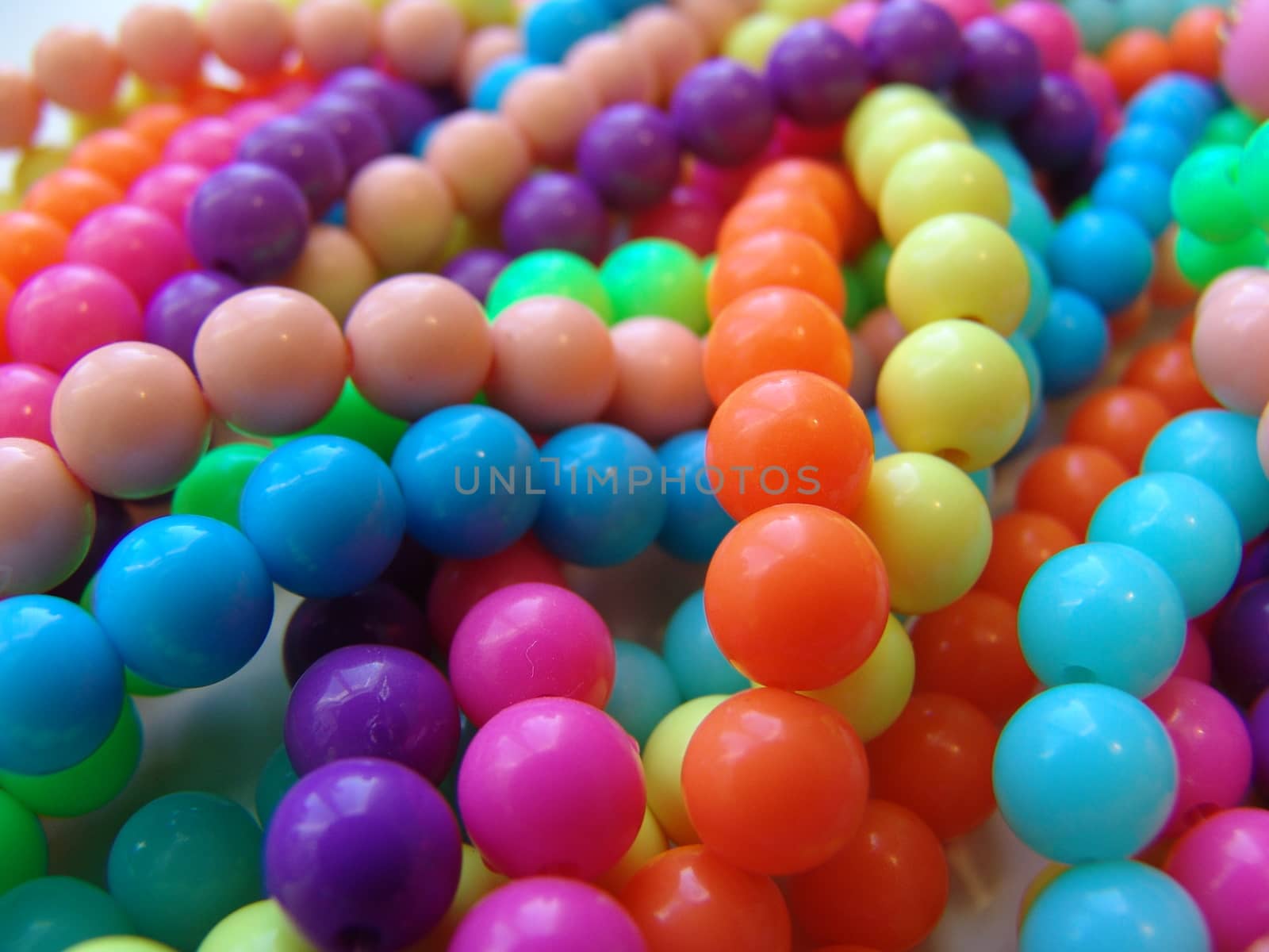 A colorful background of plastic beads in various colors.