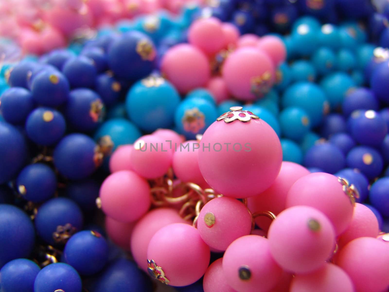 A colorful background of plastic beads in various colors. by elena_vz