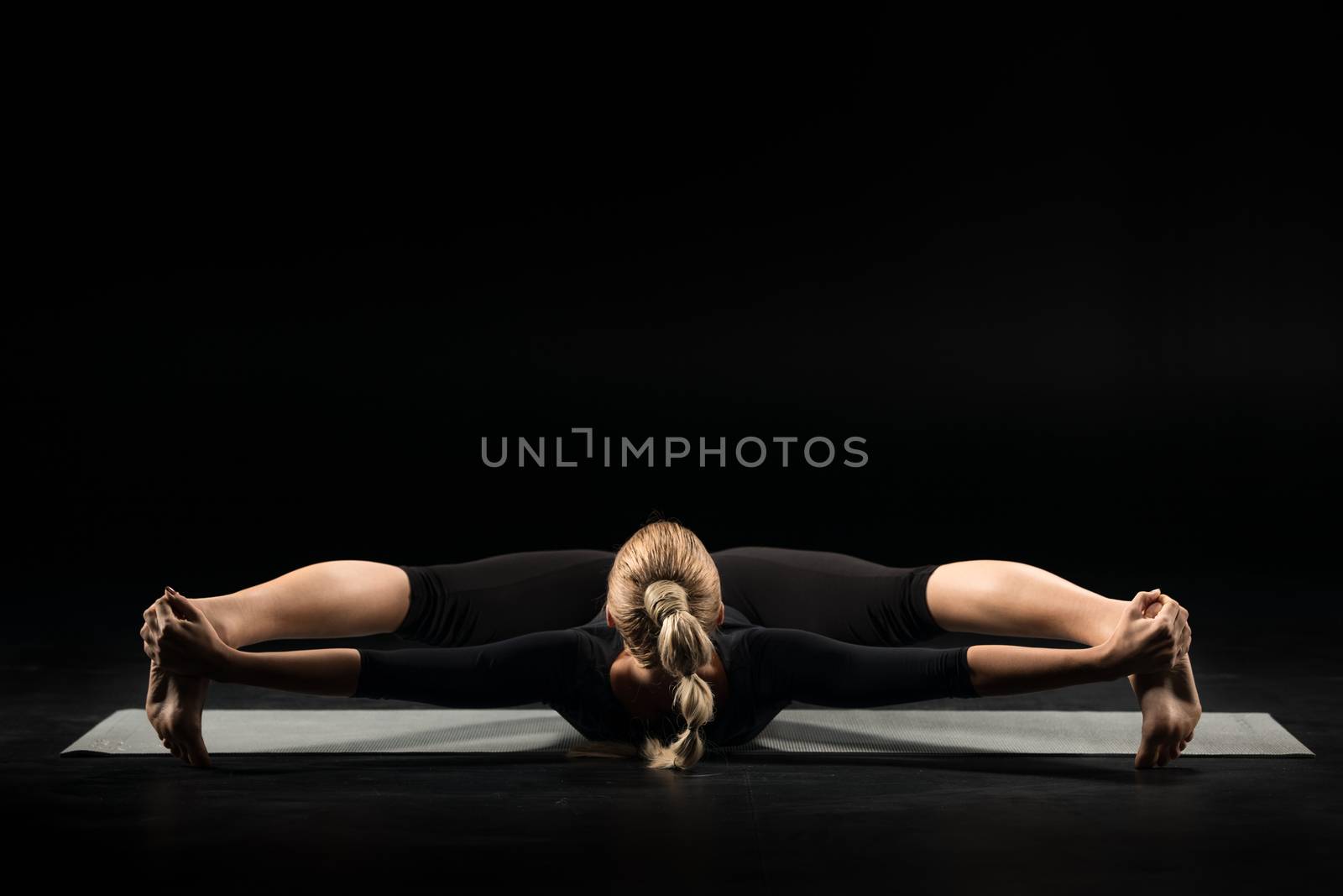 Woman lying in yoga position by LightFieldStudios