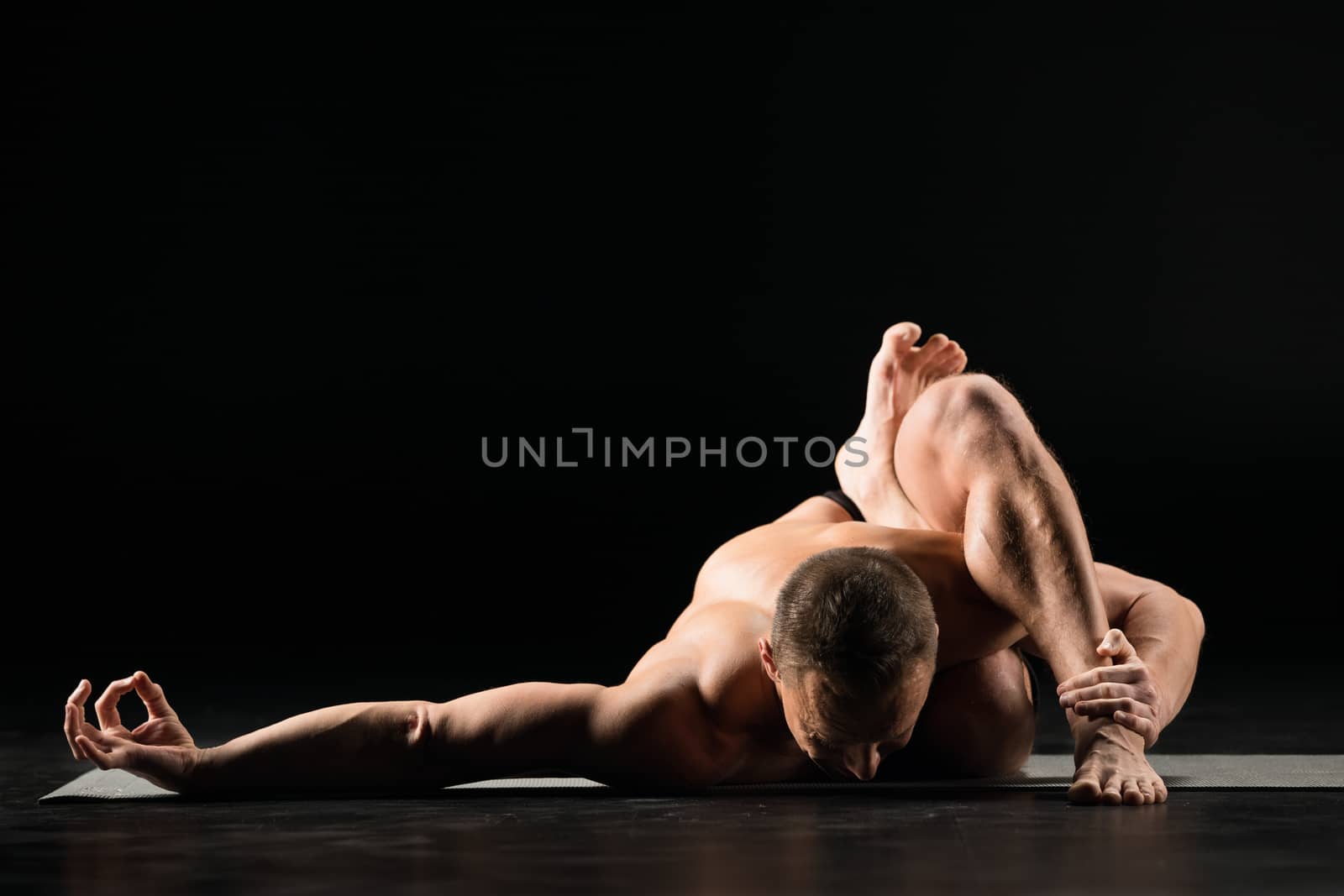 Man sitting in yoga position by LightFieldStudios