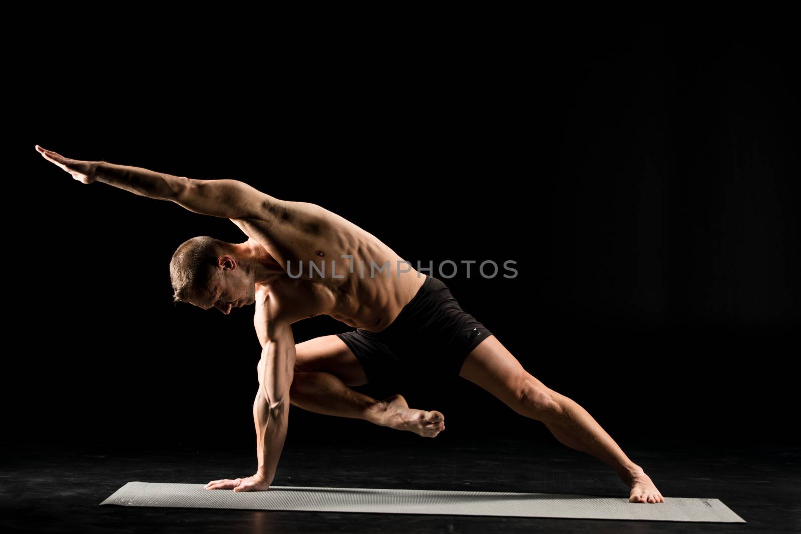 Man standing in yoga position by LightFieldStudios