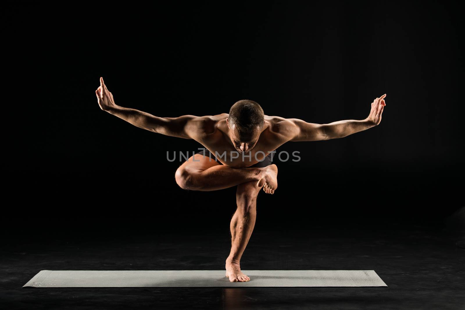 Man standing in yoga position by LightFieldStudios