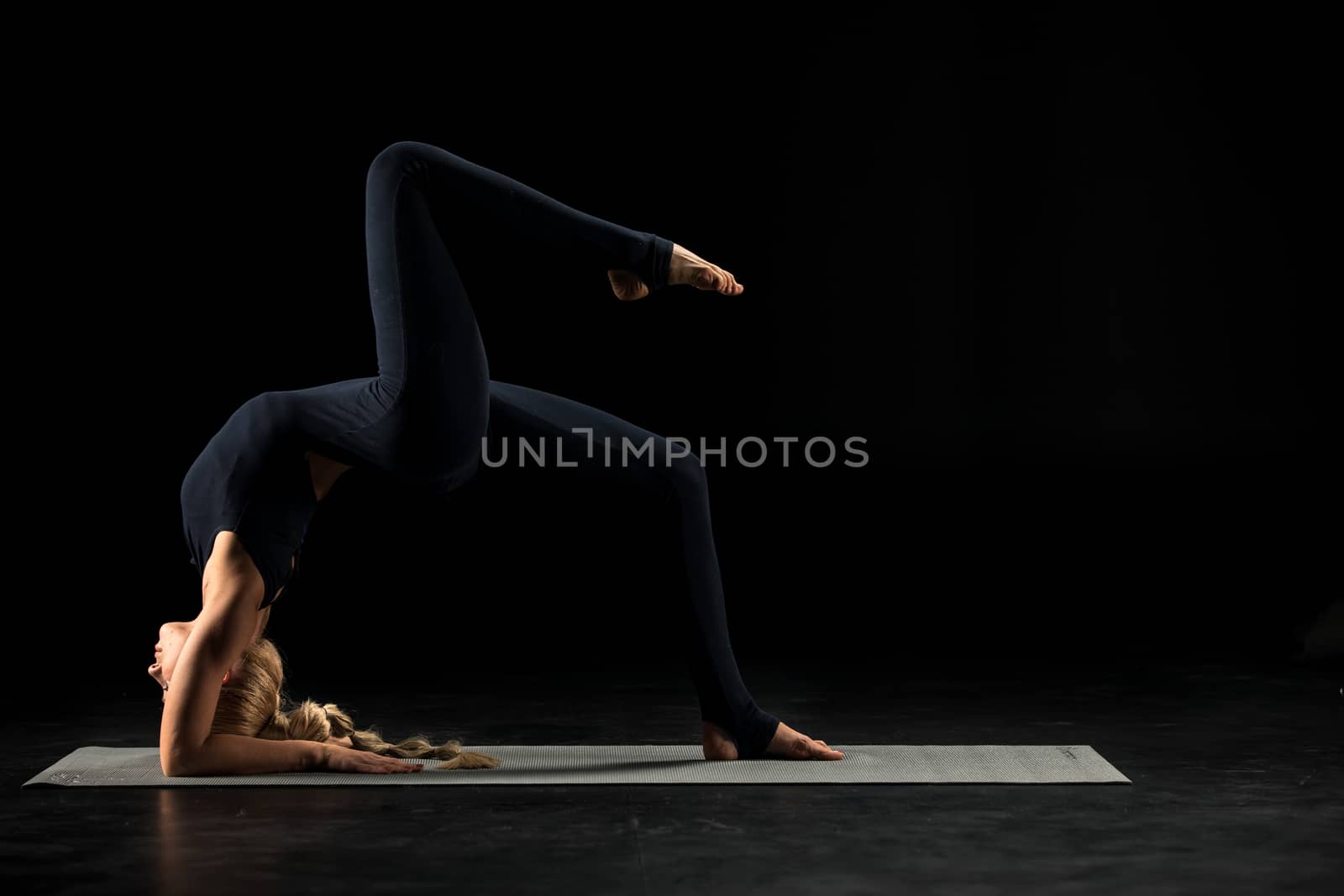 Woman standing in yoga position       by LightFieldStudios
